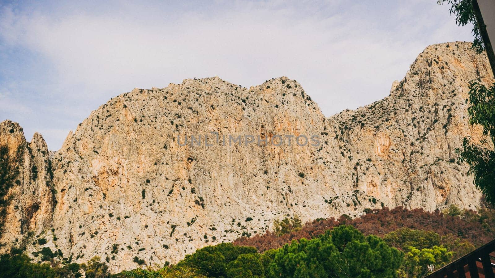 The rocky cliffs are surrounded by lush greenery, showcasing natures remarkable beauty for all to admire