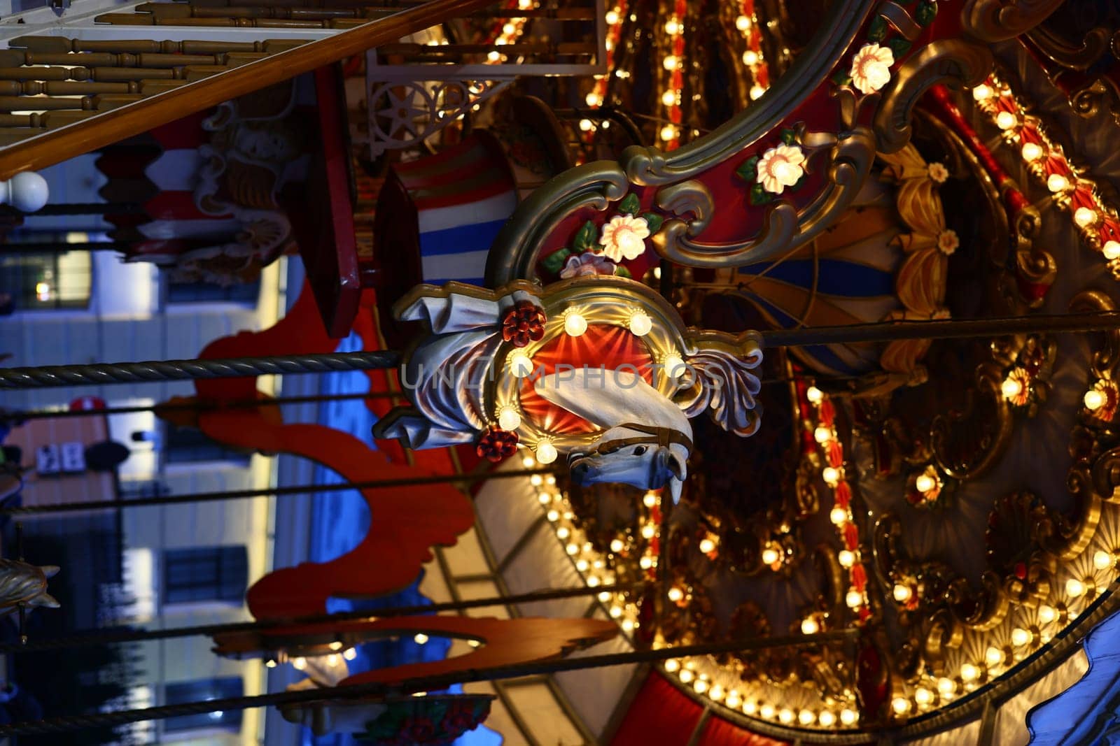 A beautifully adorned and brightly shining carousel at night, evoking a delightful sense of nostalgia and immense joy