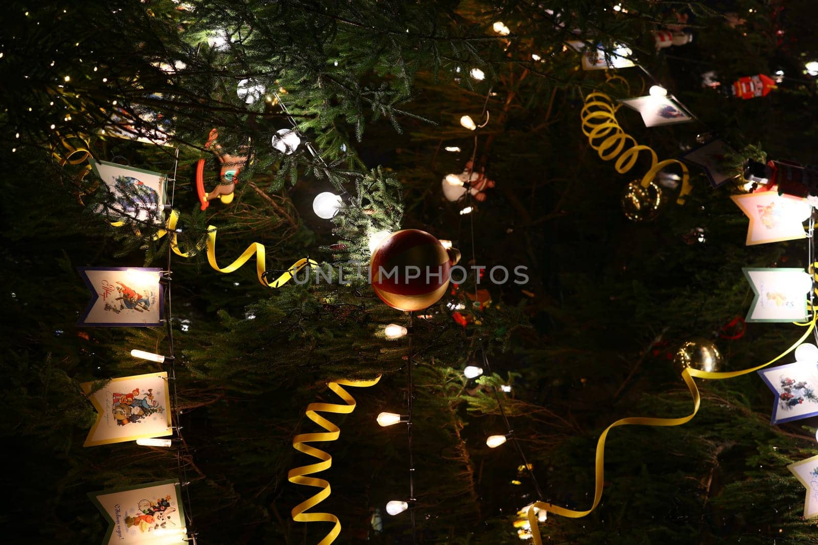 A beautifully decorated Christmas tree, beautifully adorned with vibrant lights, unique ornaments, and festive ribbons