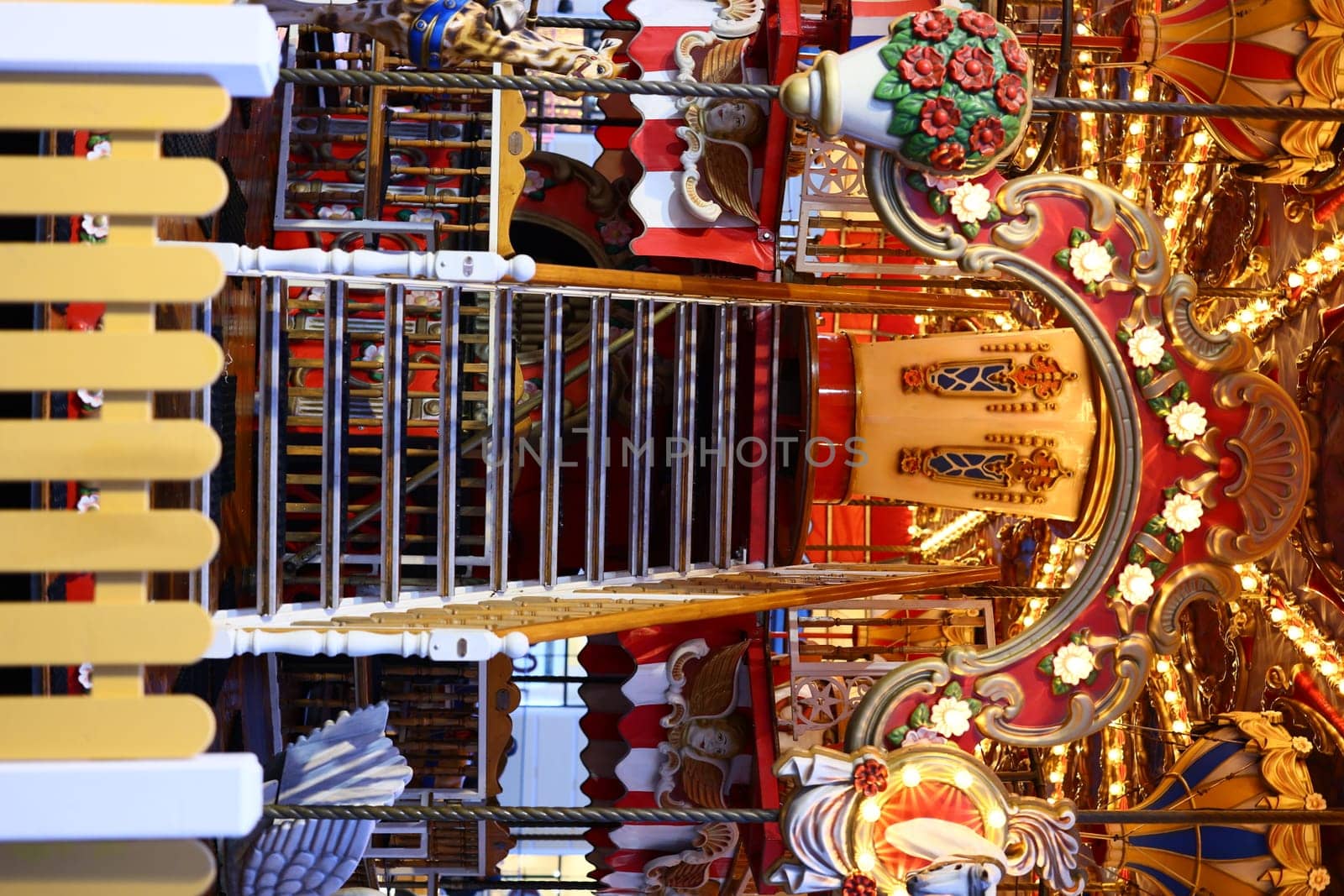 A beautifully decorated carousel staircase featuring intricate designs and warm inviting lighting throughout