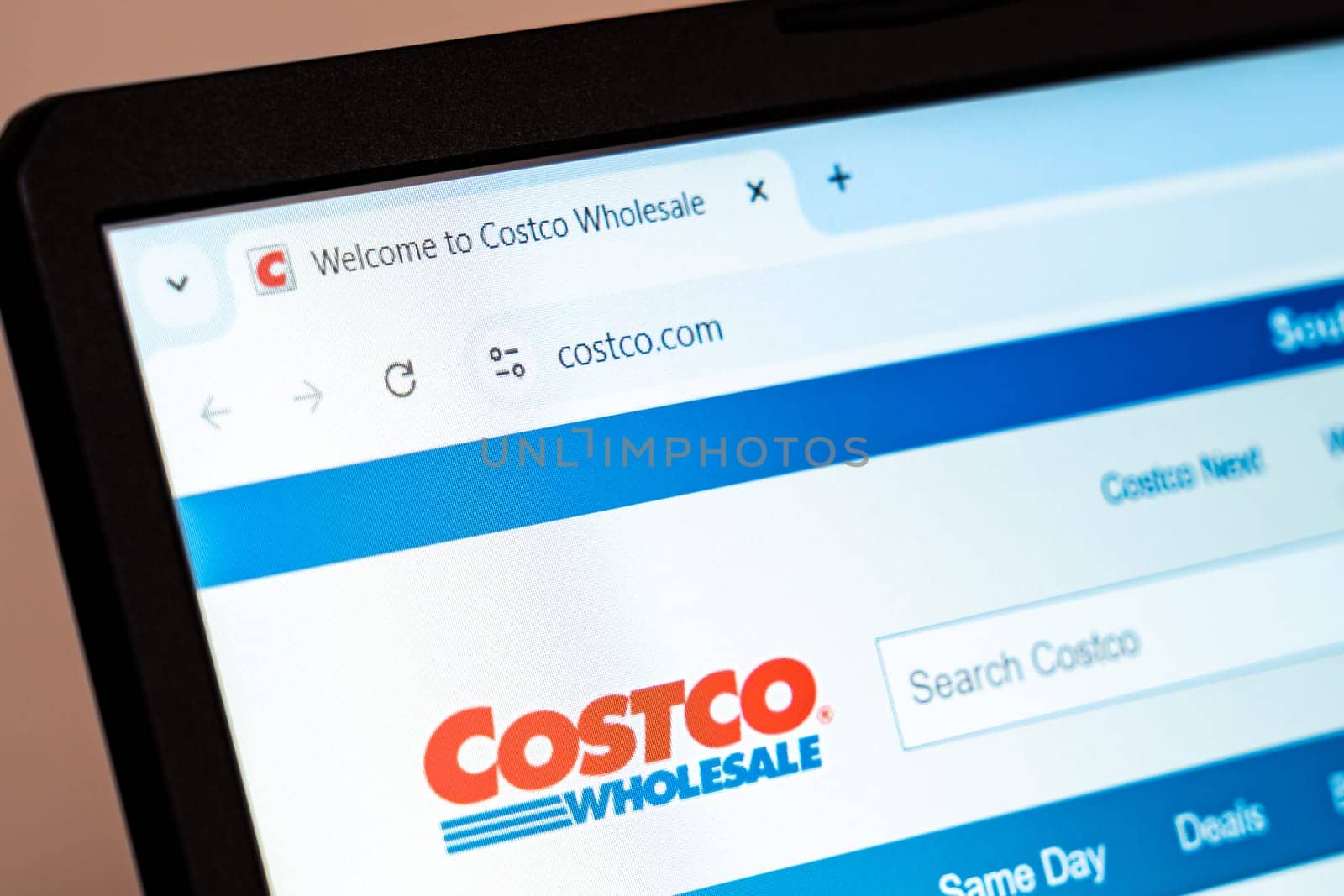 New York, USA - December 21, 2024: Costco Wholesale website homepage displayed on laptop screen with logo. Retail company offering bulk groceries, electronics, furniture, and membership services