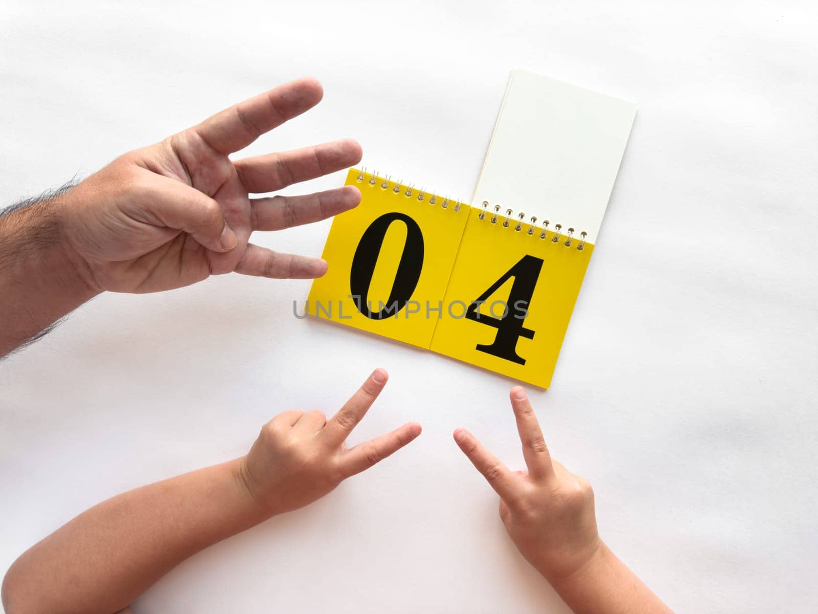 Counting hands with calendar on a white background celebrating number four.