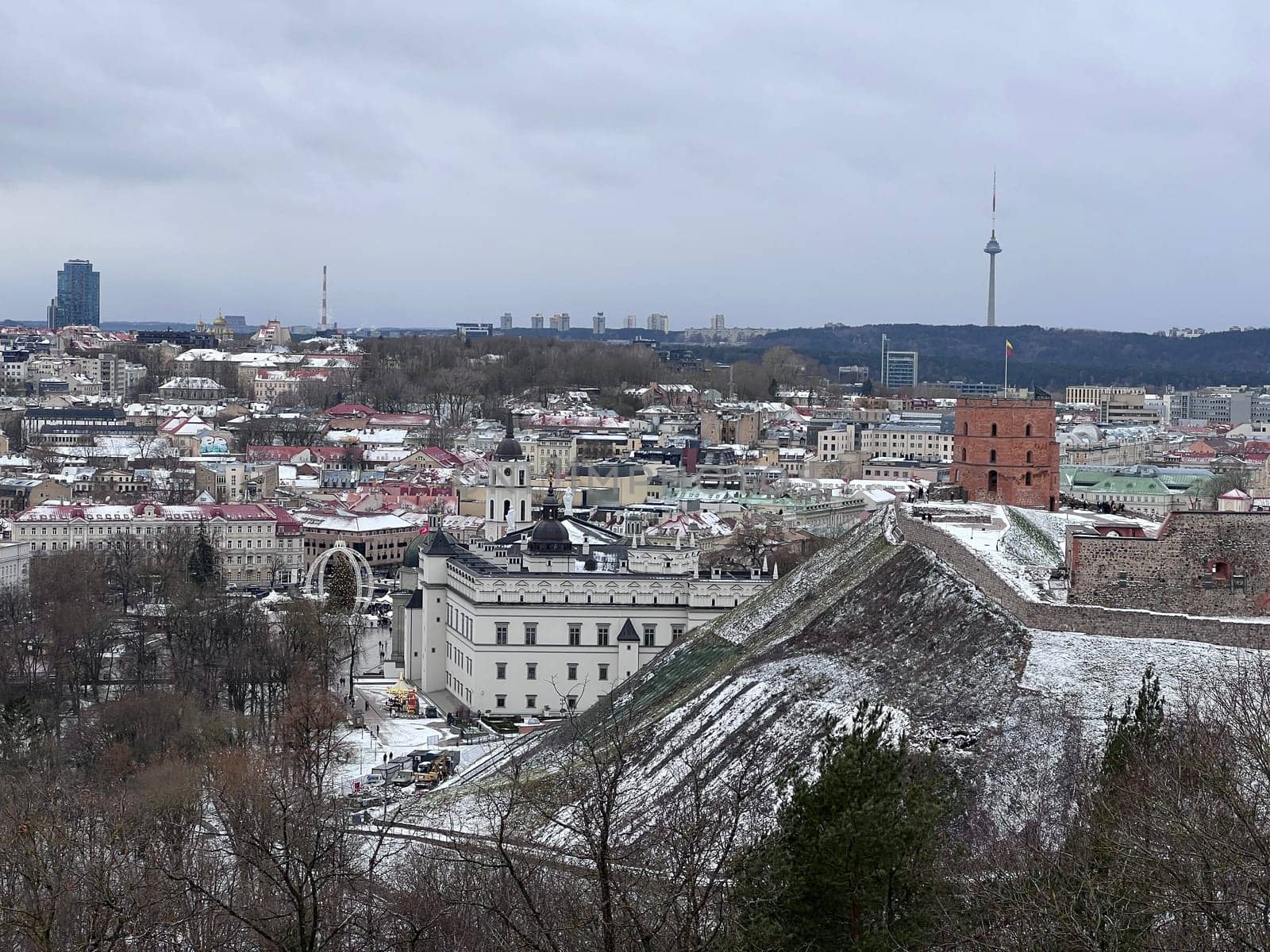 Beautiful Vilnius city panorama in winter with snow covered houses, churches and streets. Aerial evening view. Winter city scenery in Vilnius, Lithuania. High quality photo