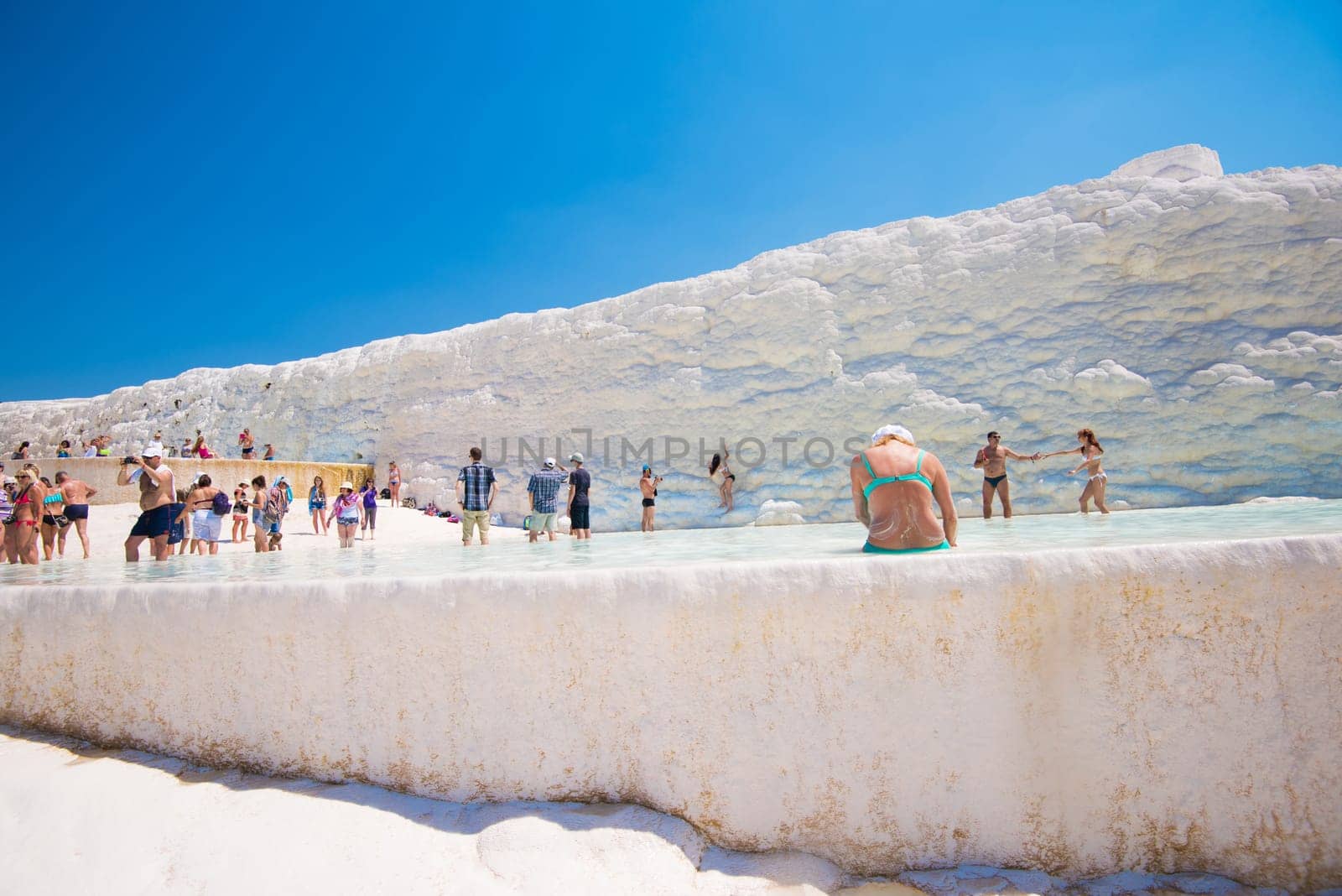 Pammukale, Turkey - July, 2015: tourists in Pammukale near modern turkey city Denizli. One of famous tourists place in Turkey.
