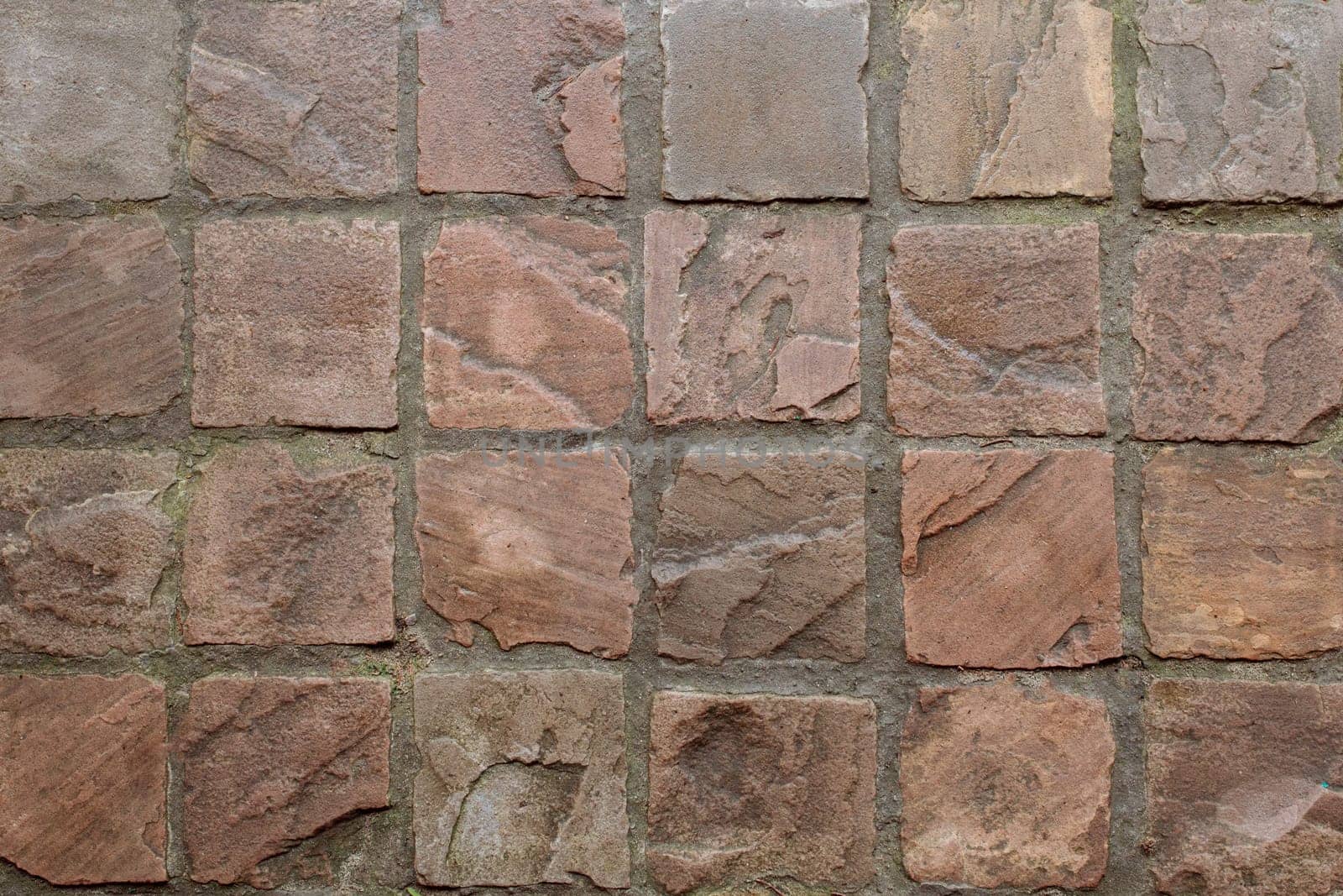 Texture of brown old granite paving stones.
