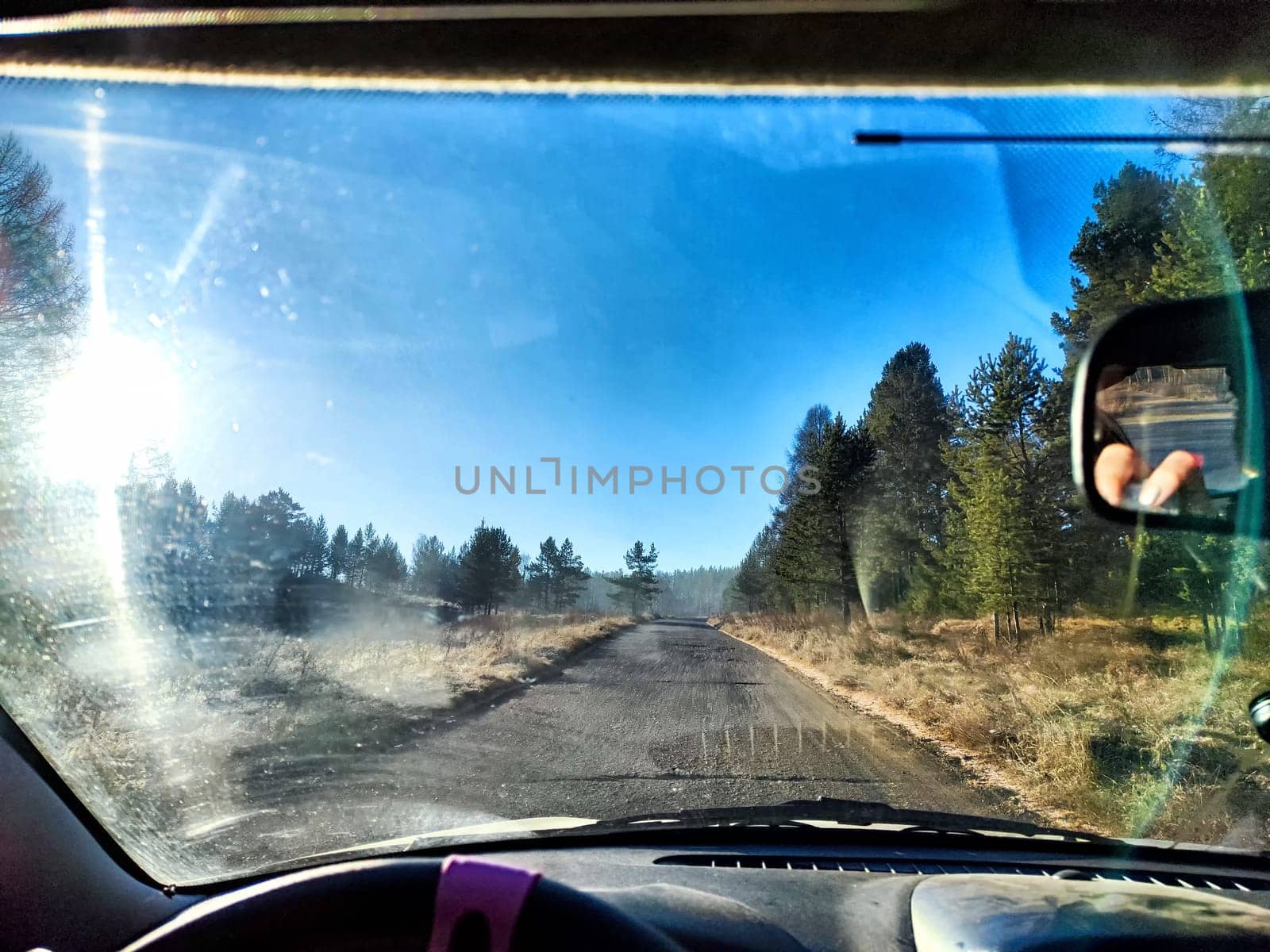 View from the car window of nature with dawn and fog in the early morning in forest