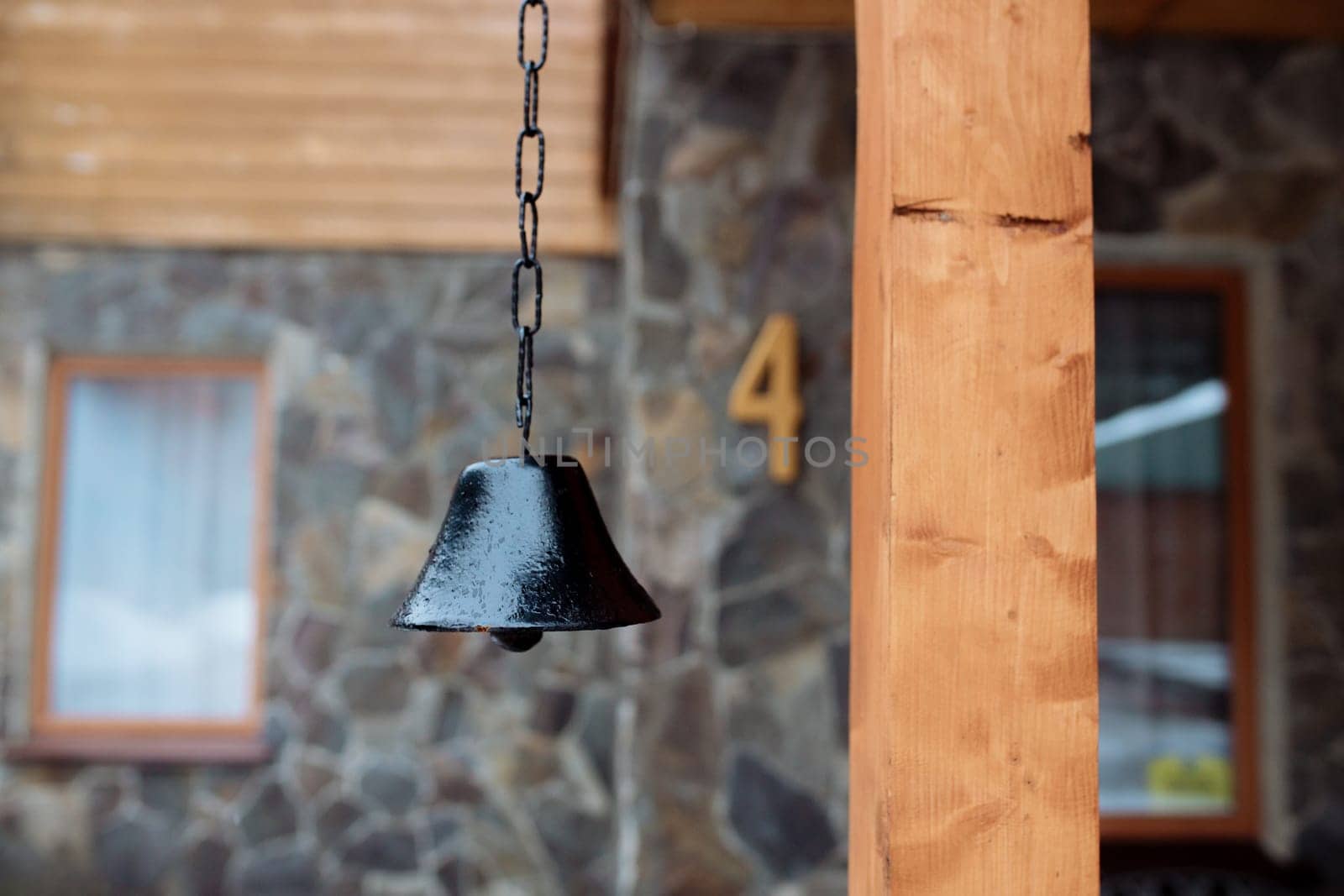 old bell on the facade of the house. The exterior of the building and design details are vintage