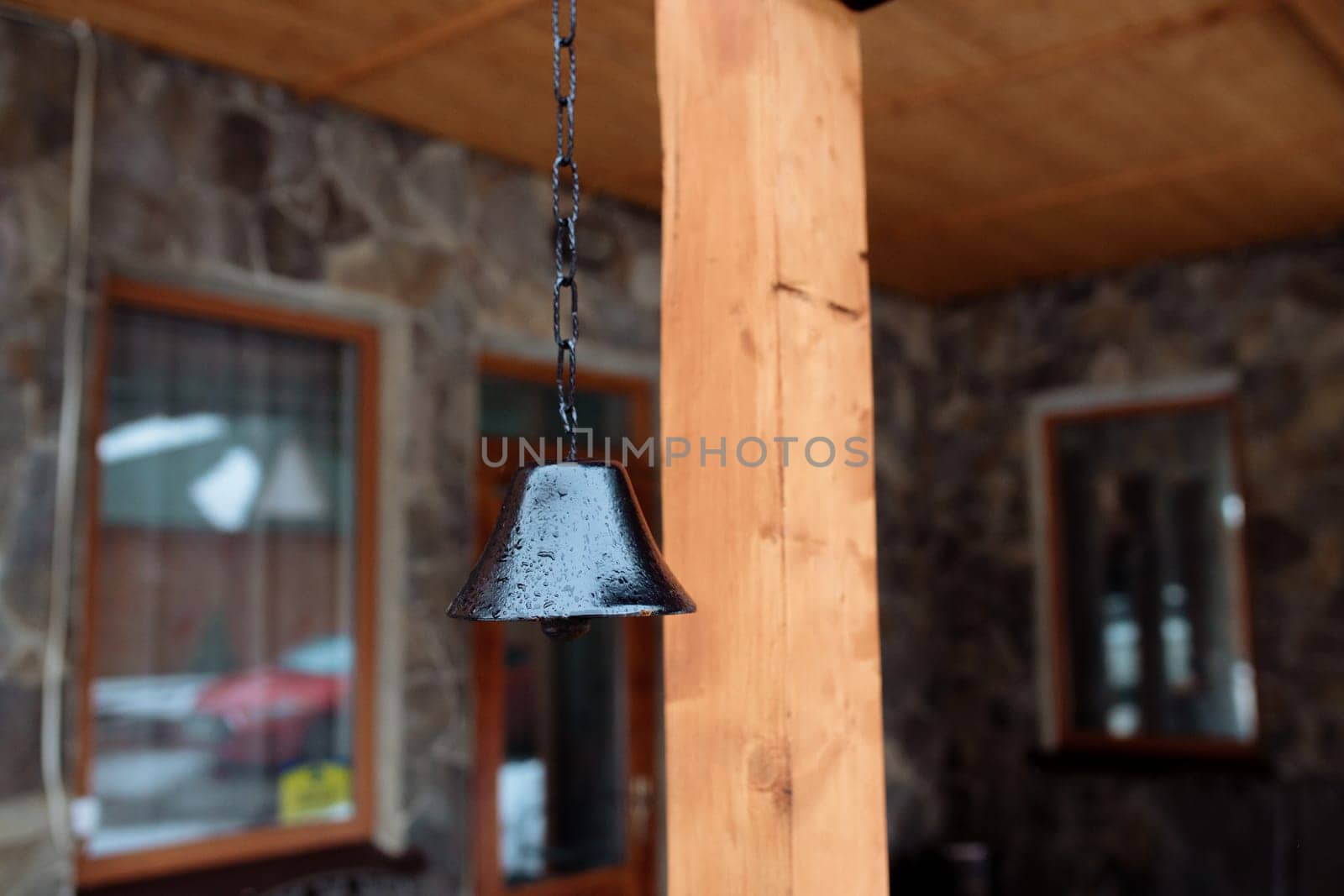 old bell on the facade of the house. The exterior of the building and design details are vintage