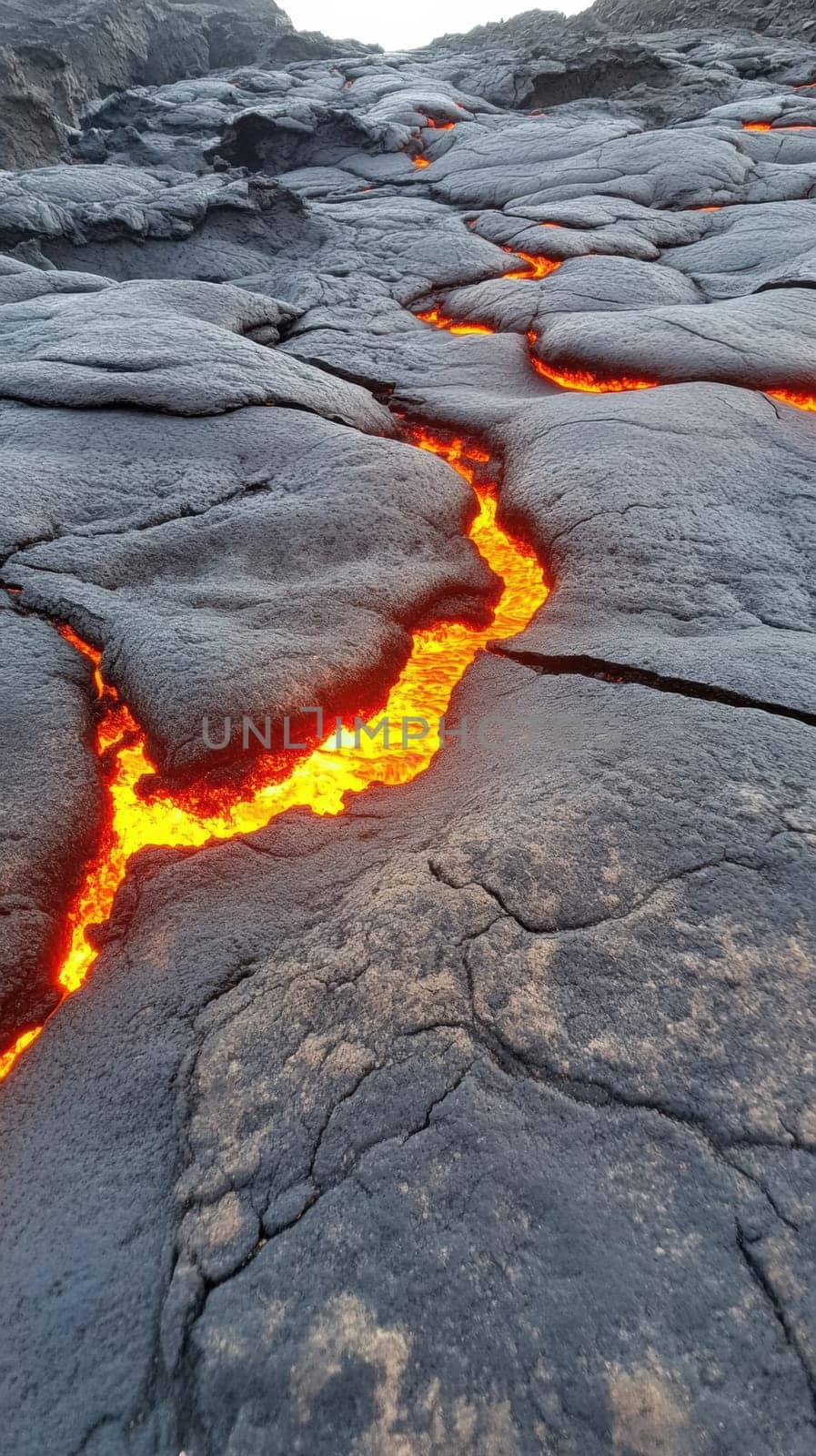 A vivid display of molten lava flowing through dark volcanic rock, showcasing the intense heat and vibrant colors of the lava against the rugged, textured surface of the cooled rock