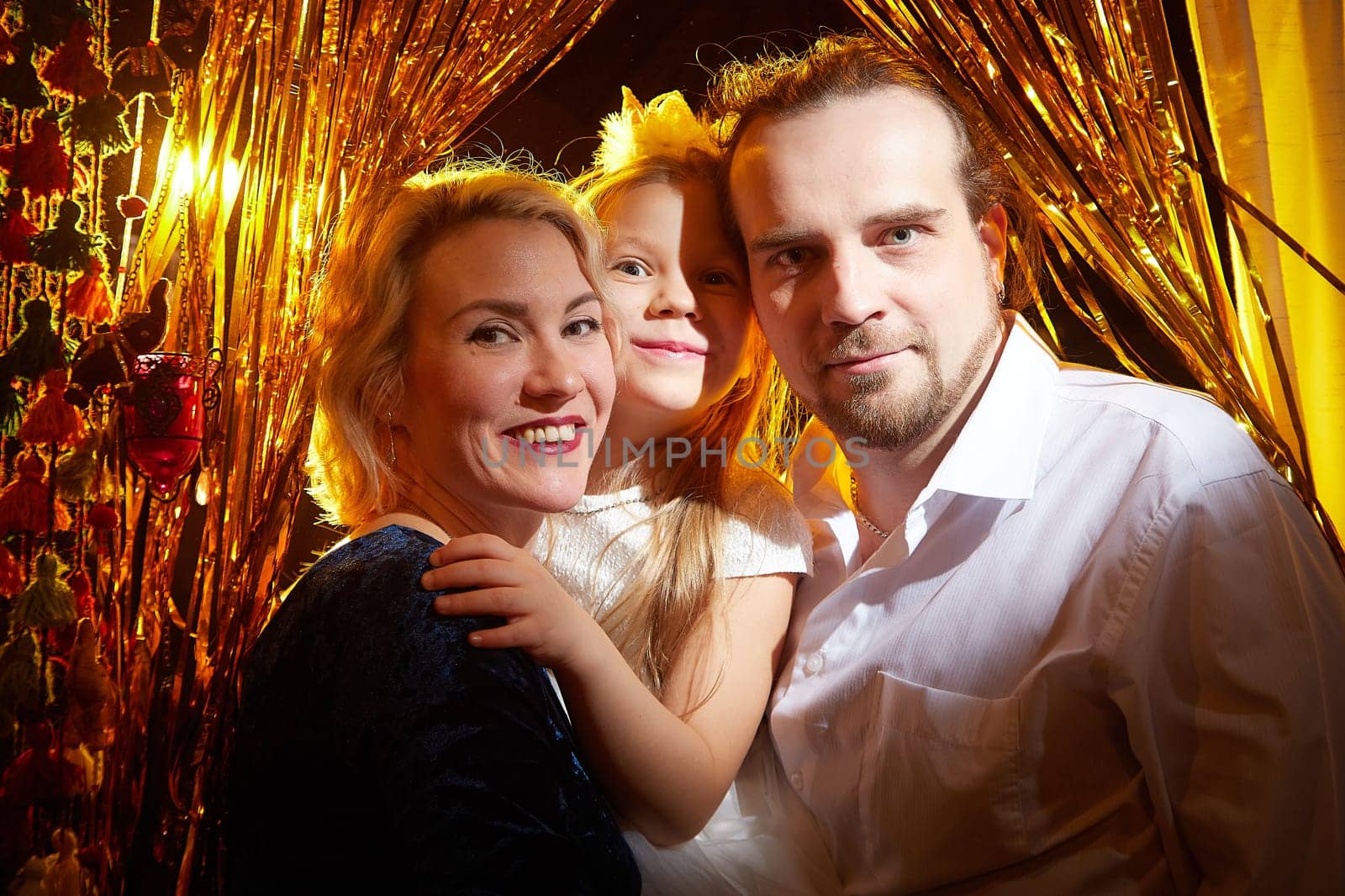 Joyful family embraces the holiday spirit, celebrating Christmas and New Year amidst shimmering decorations and bright lights.