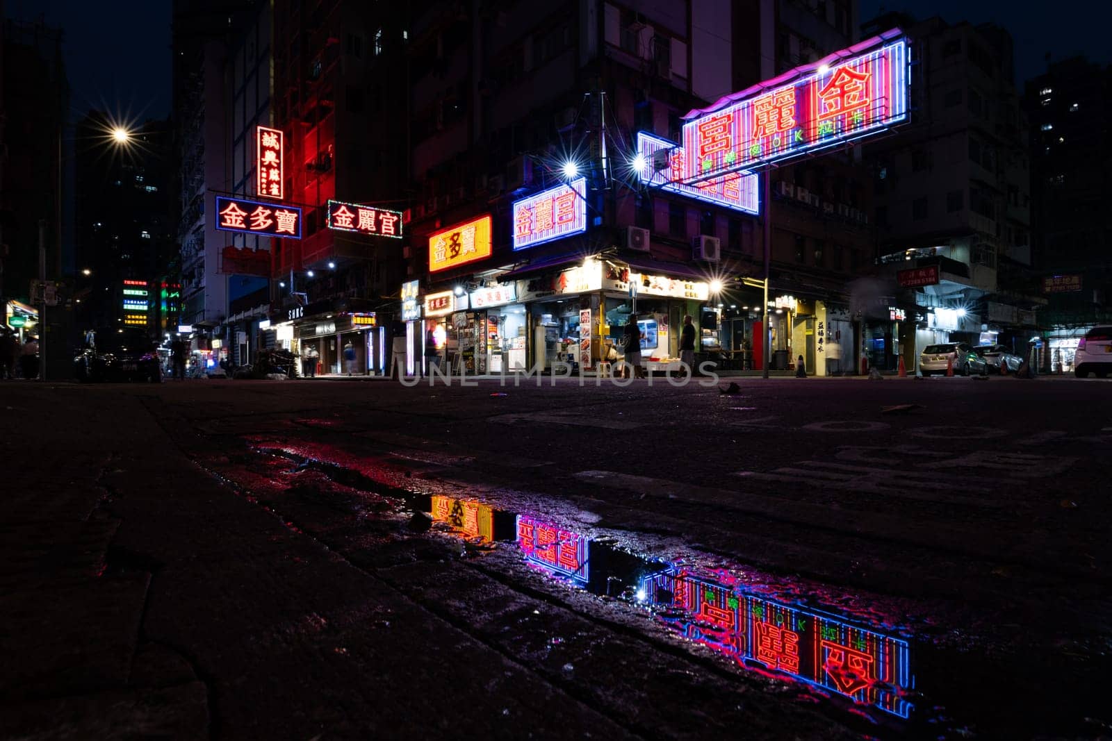 HONG KONG, CHINA - SEPTEMBER 28, 2024: Busy street corner at night with famous old neon signage in Portland St, Mongkok on Kowloon in Hong Kong