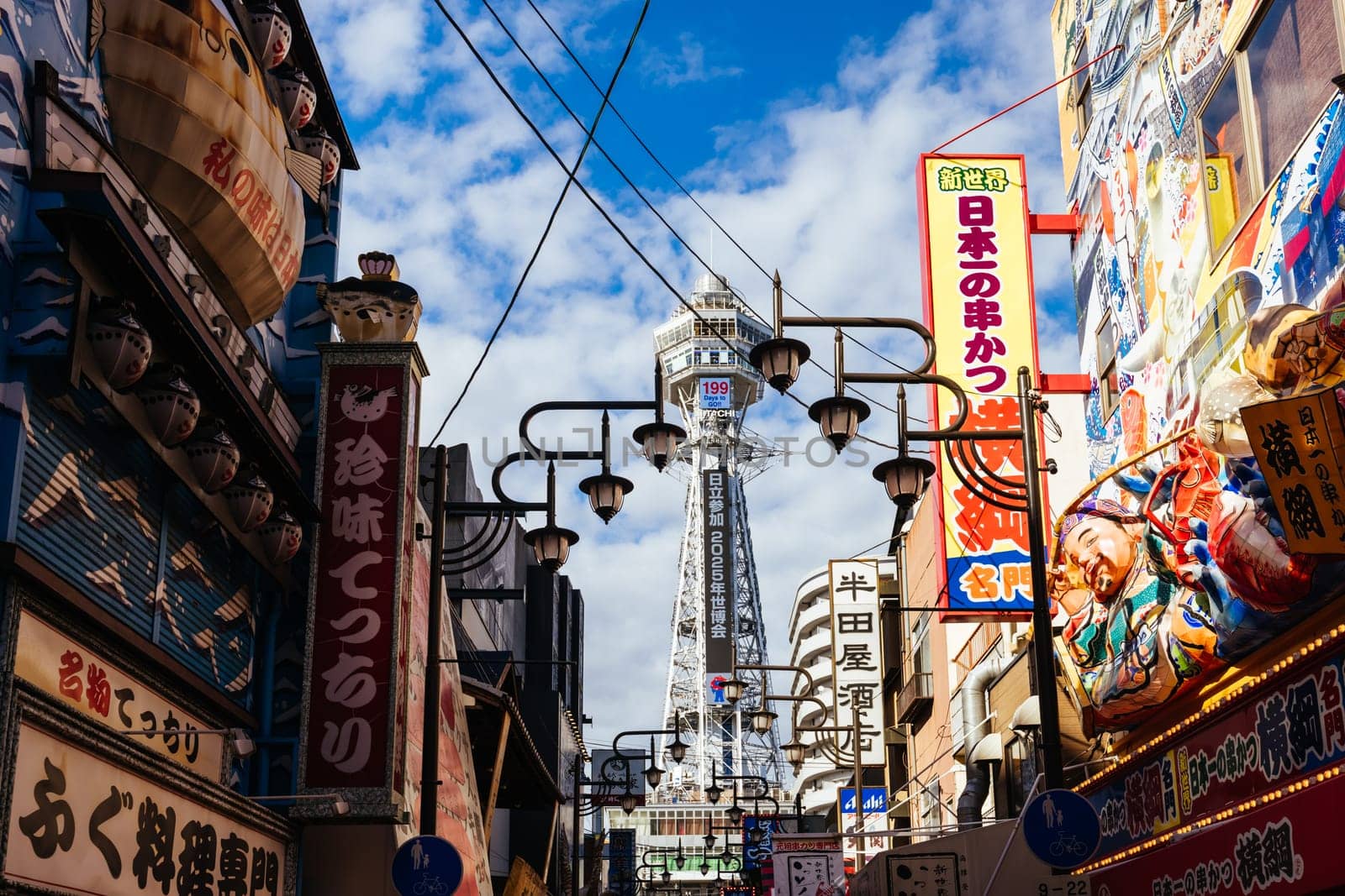 OSAKA, JAPAN - SEPTEMBER 26 2024: The famous Shinsekai area with Tsutenkaku Tower on a clear autumn day in Osaka, Japan