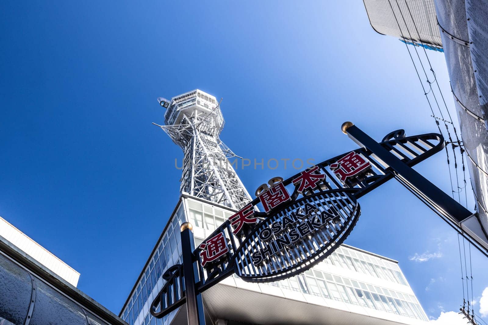 OSAKA, JAPAN - SEPTEMBER 26 2024: The famous Shinsekai area with Tsutenkaku Tower on a clear autumn day in Osaka, Japan