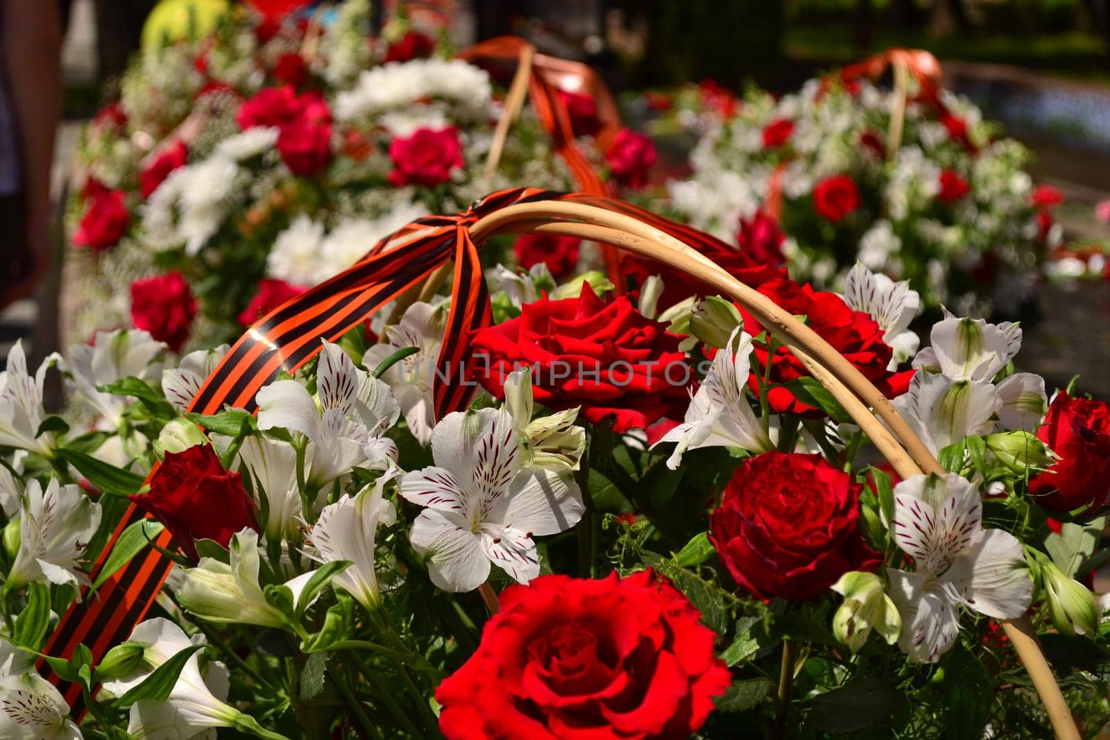 Basket with red rose and lily flowers Saint George ribbon