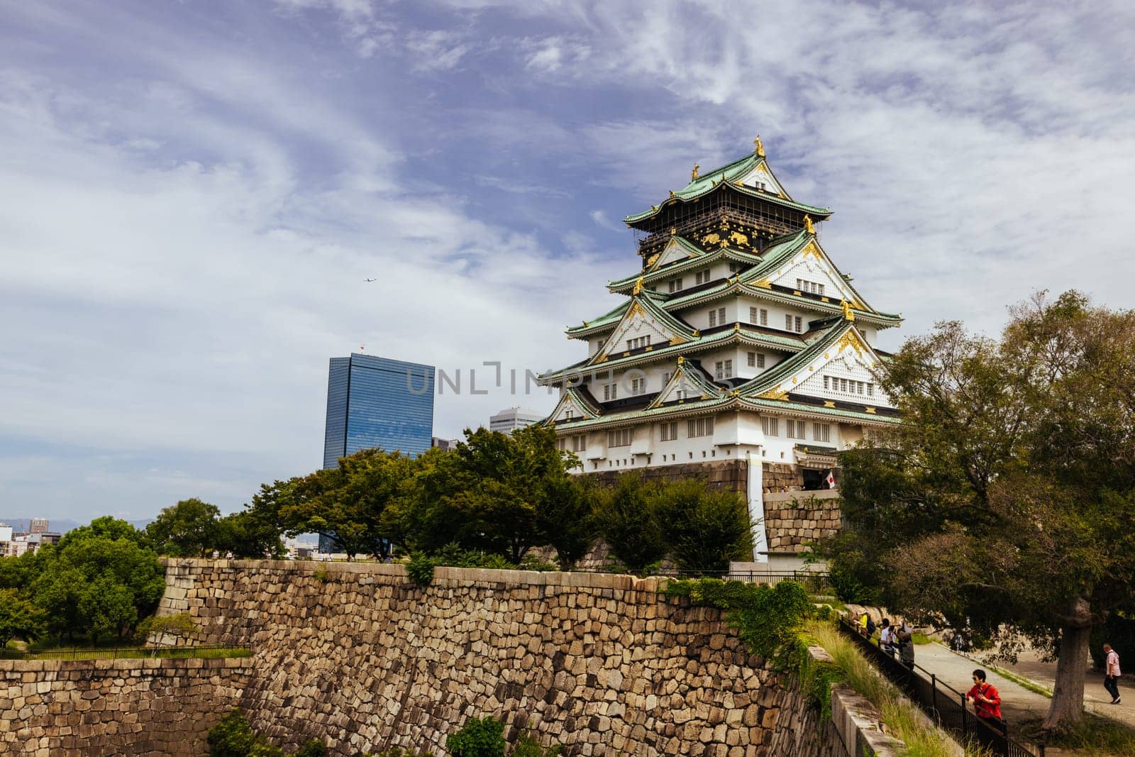 OSAKA, JAPAN - SEPTEMBER 25 2024: The iconic Osaka Castle and lush surrounds on a warm clear autumn day in Osaka, Japan on September 25th 2024