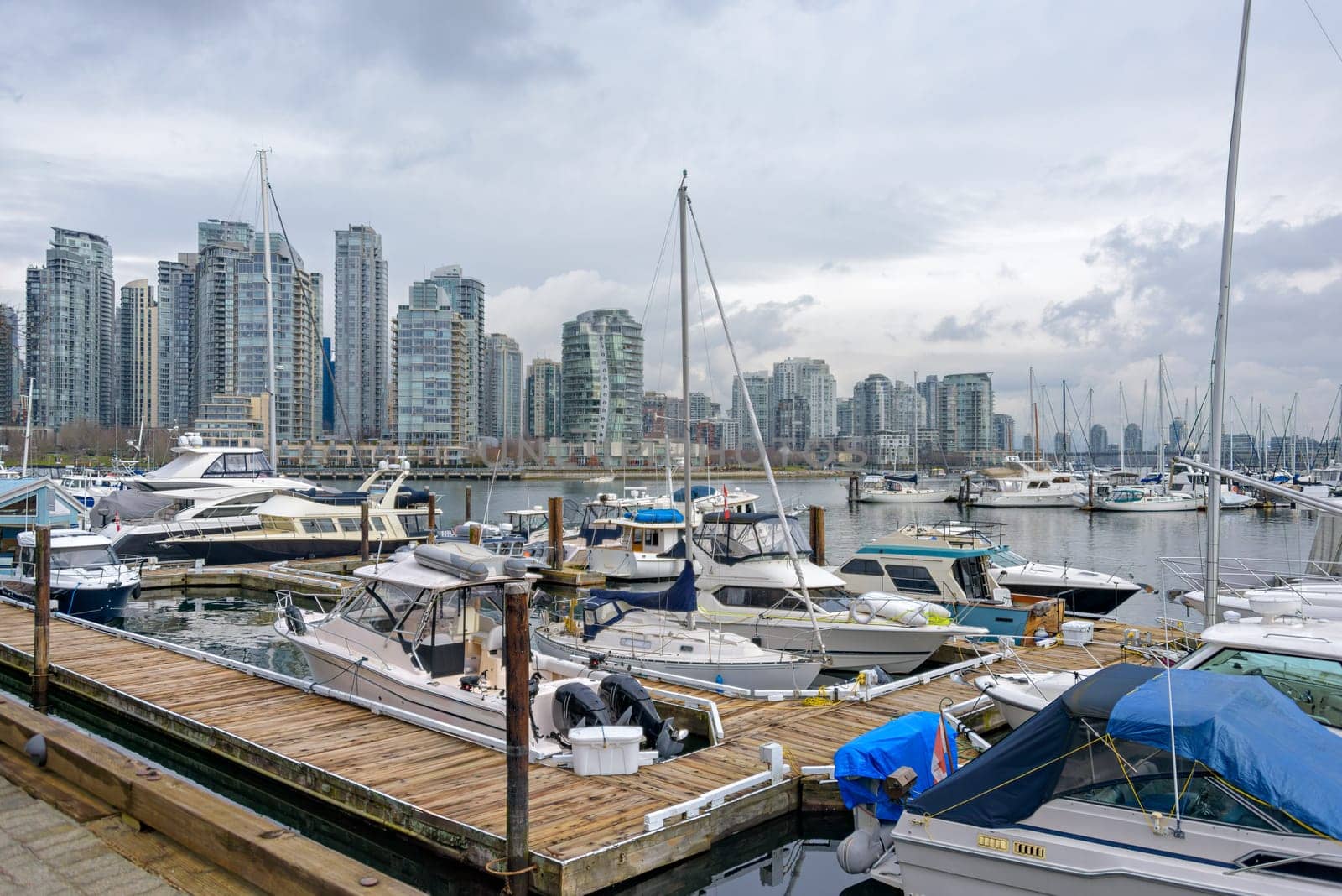 Yachts and boats moored at the pier in downtown of Vancouver, Canada.