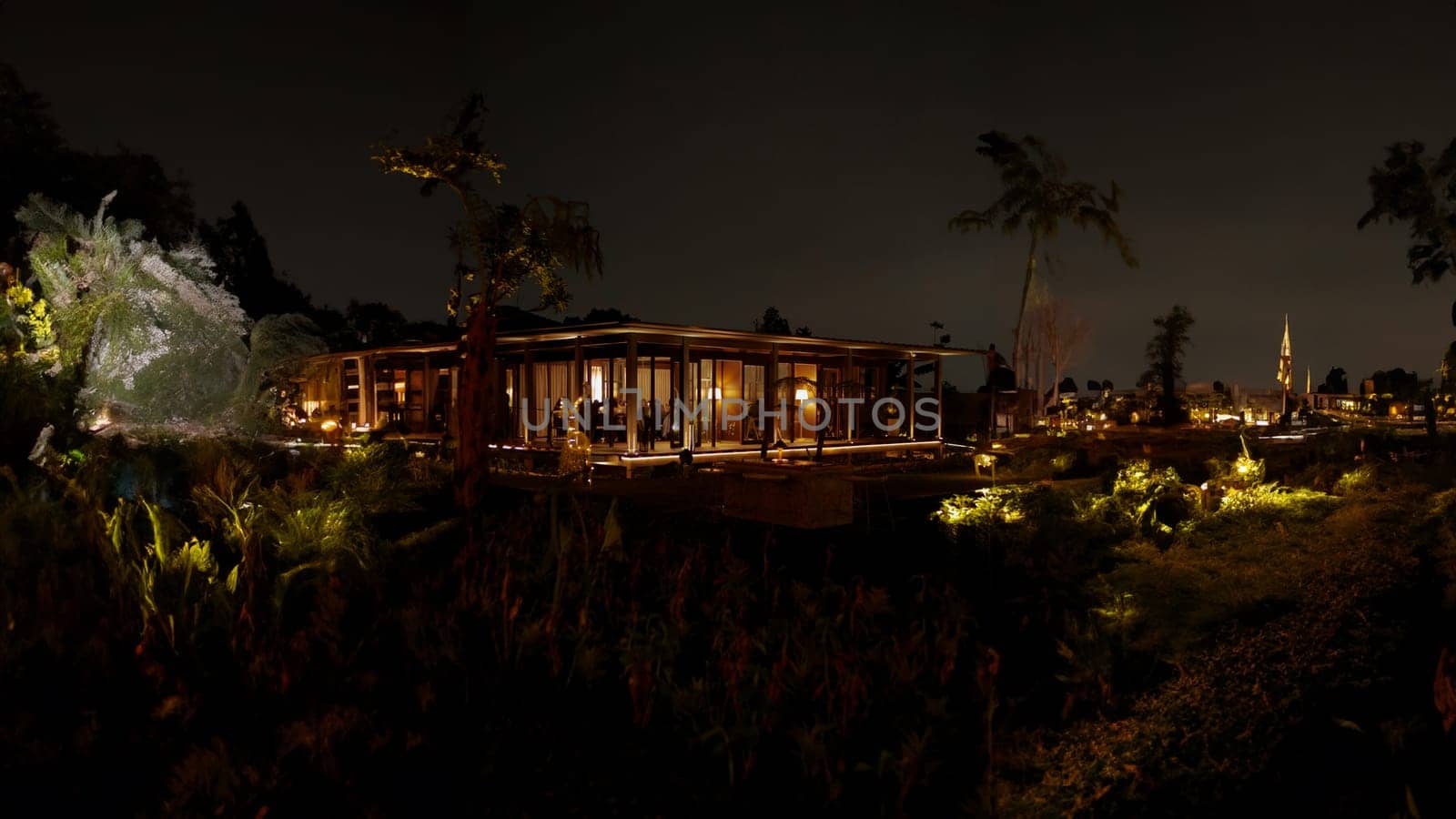 Serene night landscape with illuminated wooden cabin and glowing plants, creating a magical atmosphere in the dark night