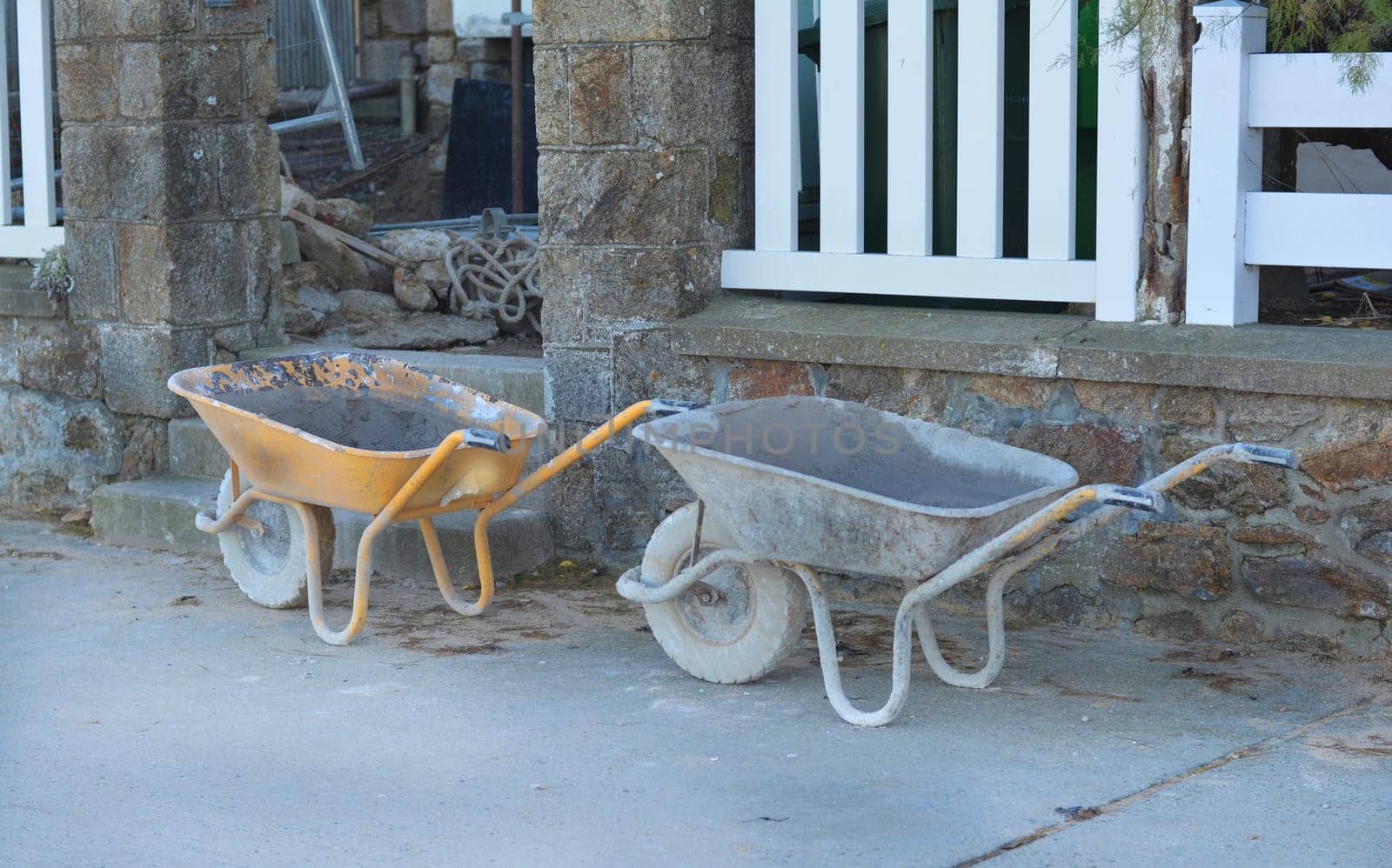 Construction wheelbarrows standing at a building site.