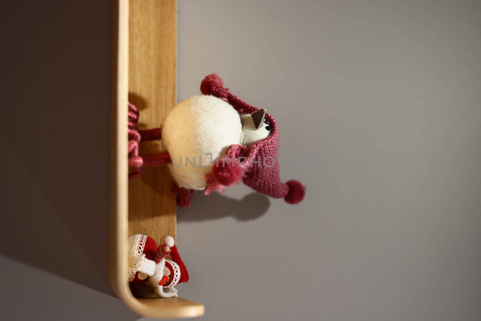 Charming and whimsical holiday decorations adorned with cute characters displayed on a beautifully crafted wooden shelf