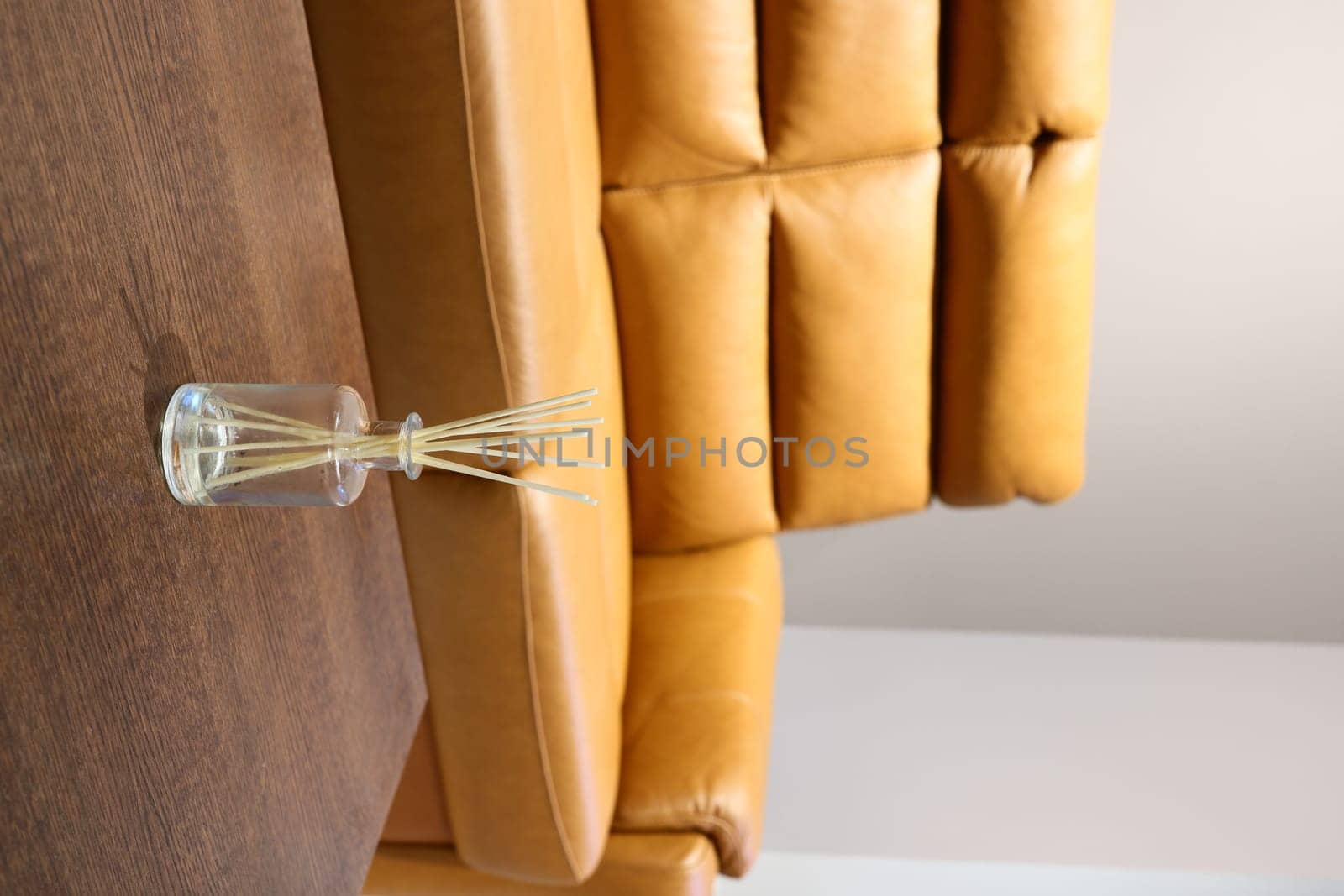 This stylish living room area showcases a beautifully warm yellow sofa along with an inviting decorative diffuser piece
