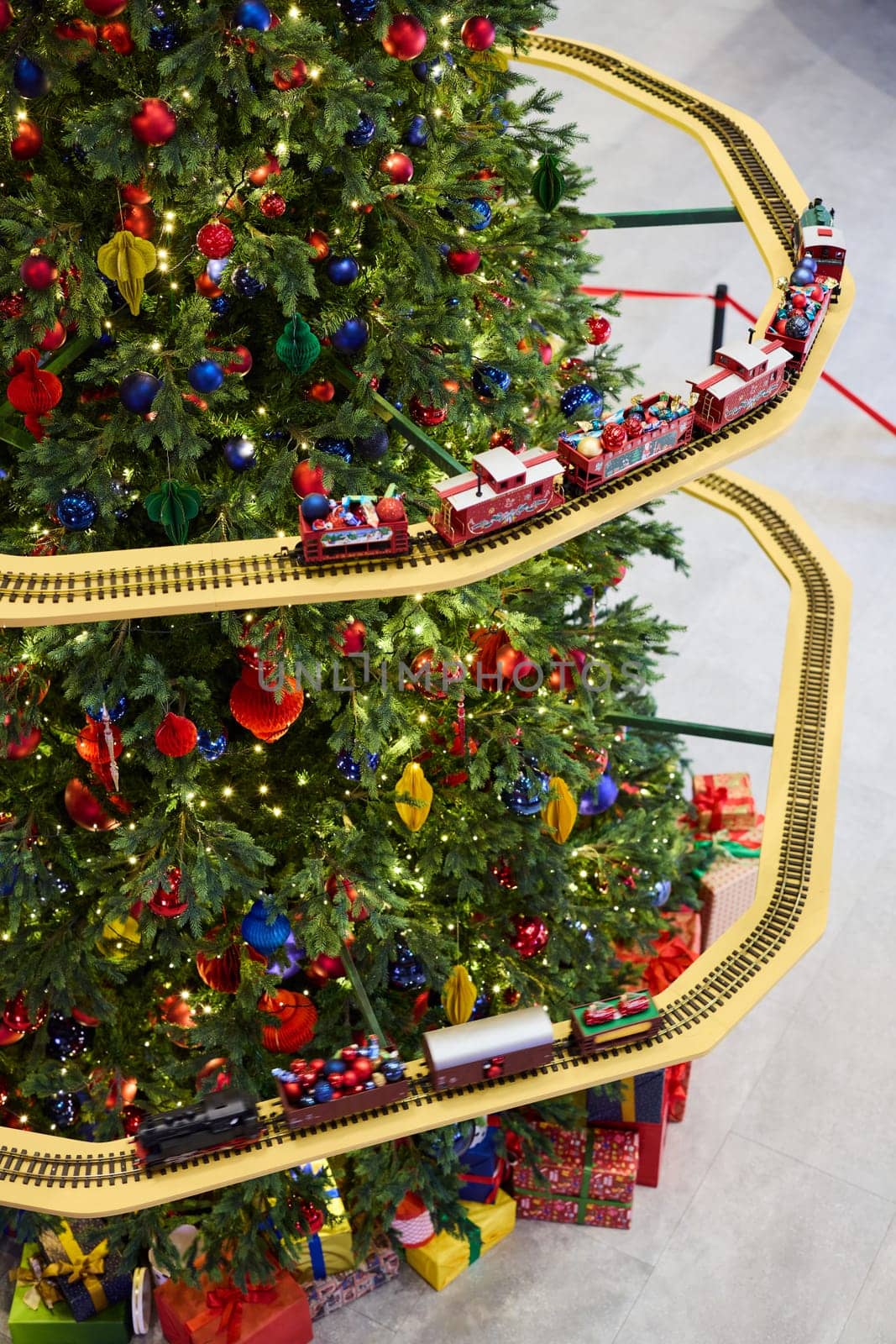 A festive Christmas tree with colorful ornaments and a charming model train, creating a joyful holiday scene