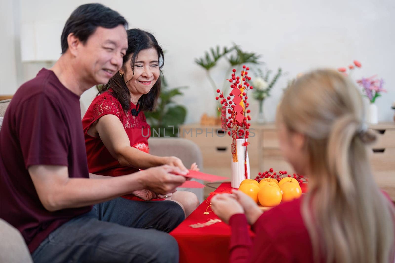 A heartwarming Chinese New Year celebration with grandparents and their granddaughter embracing family traditions and joy.