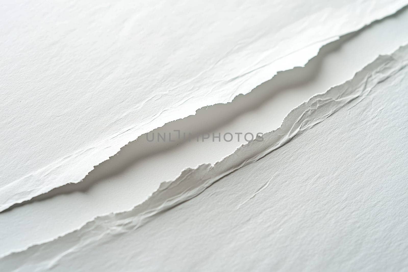 High-resolution close-up of a tear diagonally running across a white sheet of paper. the fibers are vividly visible along the ripped edges, creating a striking textured effect. ideal for design projects emphasizing authenticity and detail.