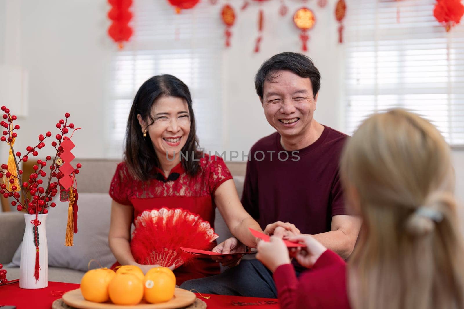 Family bonds strengthen as grandparents and granddaughter celebrate Chinese New Year together at home.