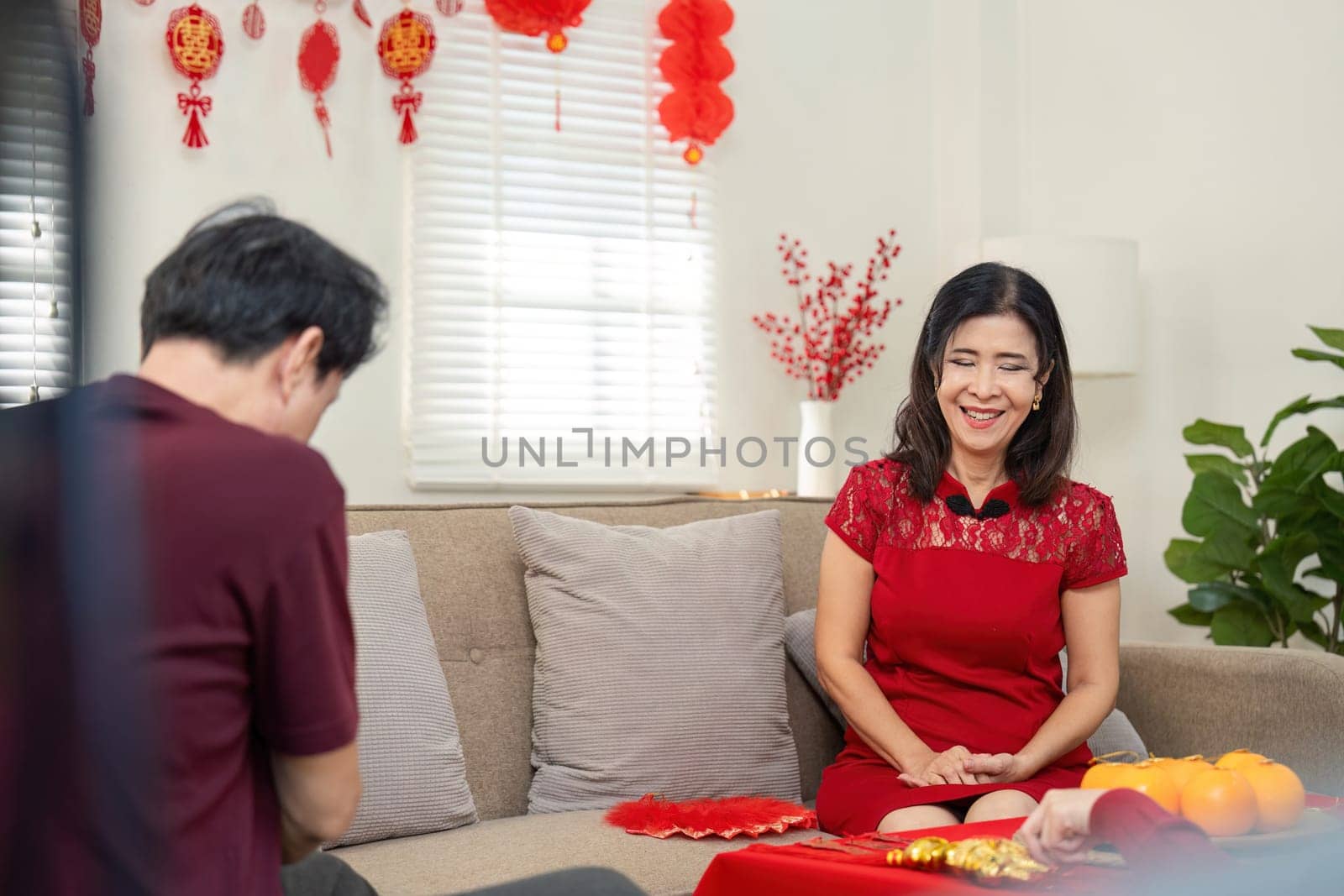 A joyous gathering as a granddaughter shares heartfelt moments with her grandparents during Chinese New Year celebrations.