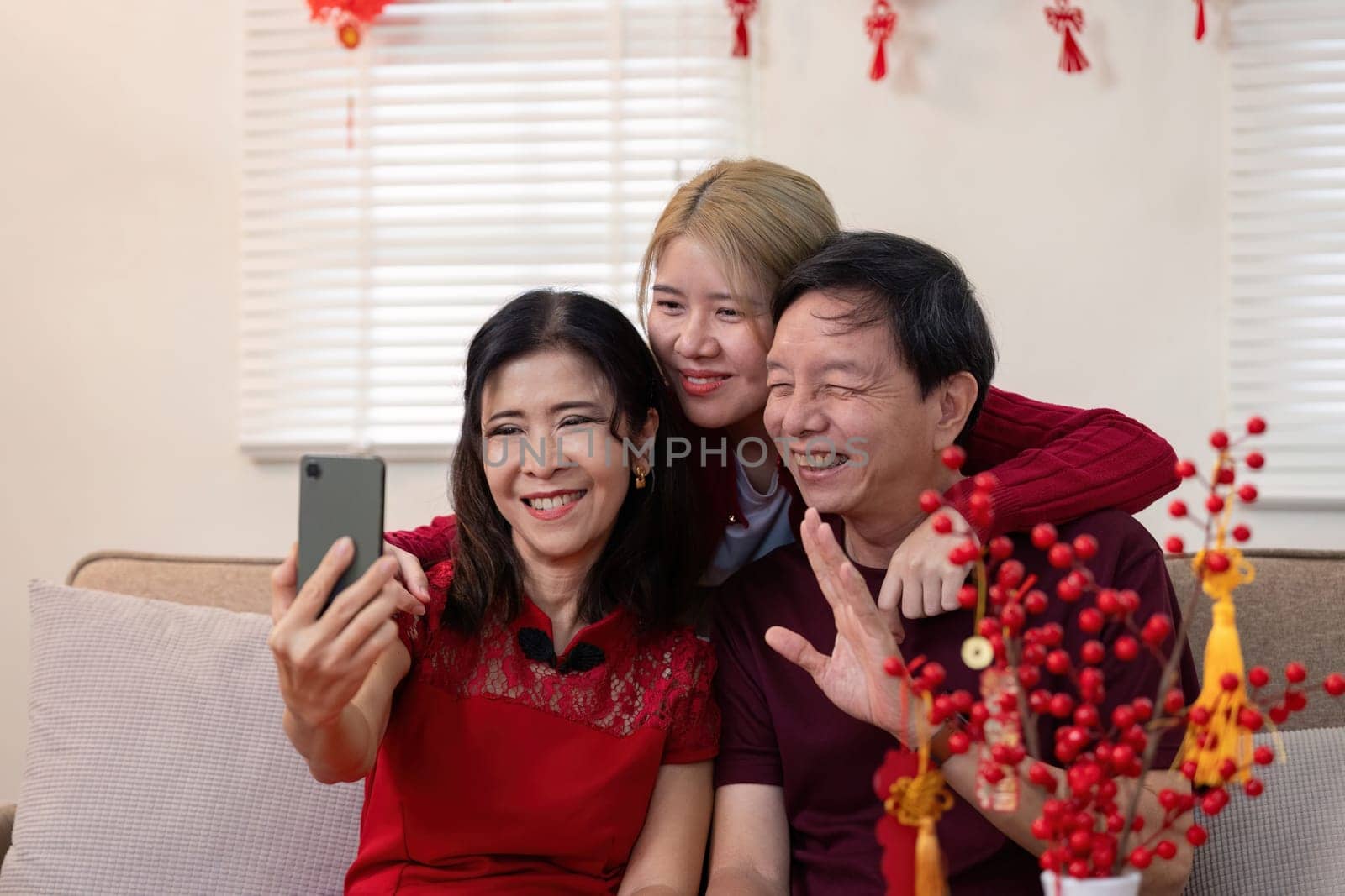 A warm family moment during Chinese New Year with grandparents and granddaughter capturing smiles and love.