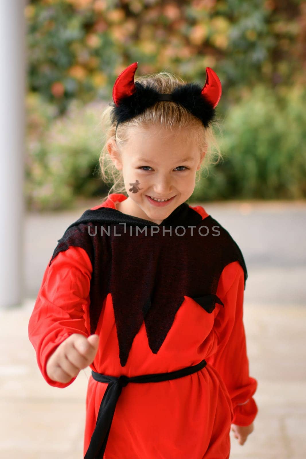 Scary girl dressed as a devil with horns