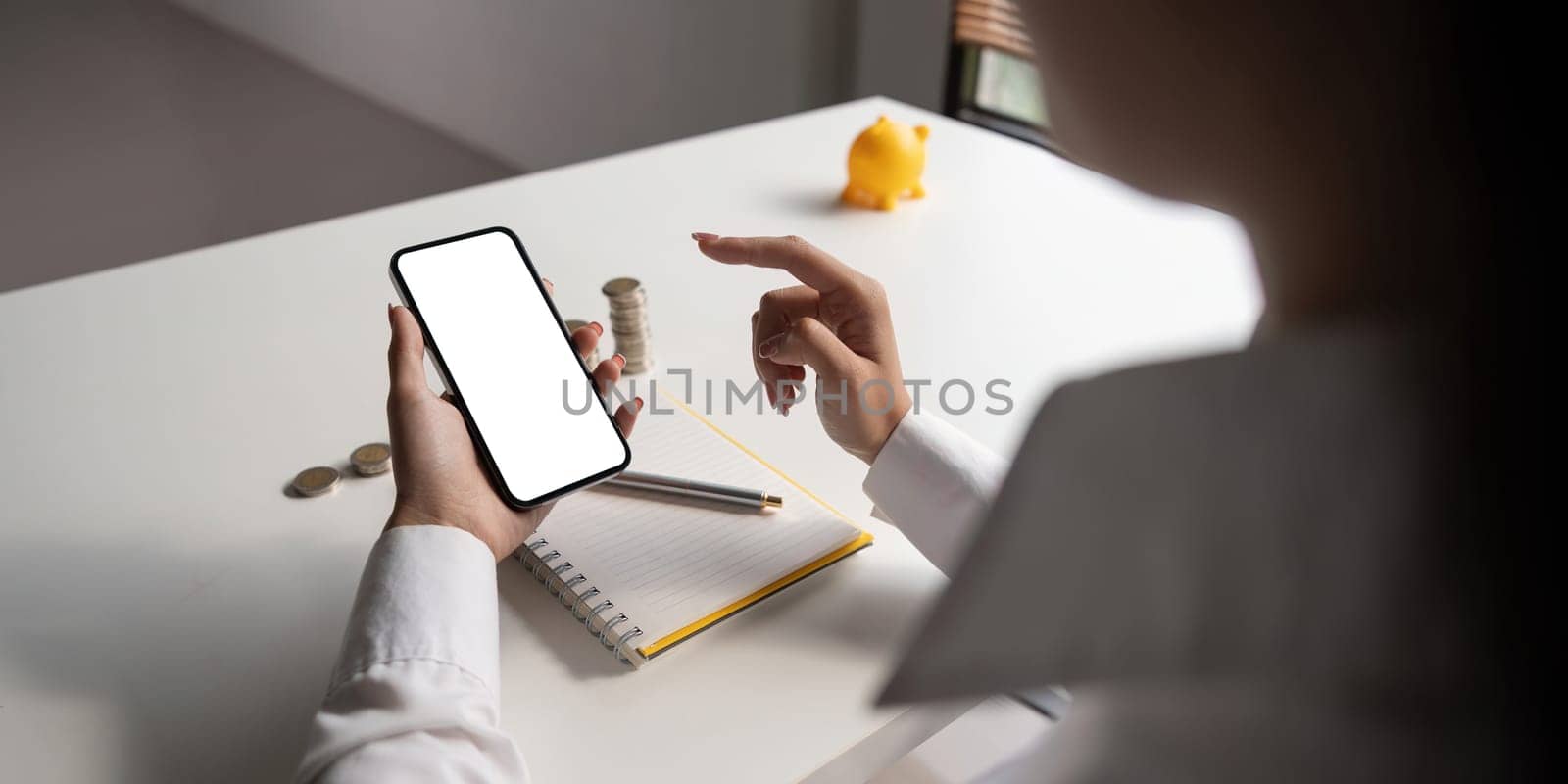 Close up of woman hold use cellphone with white mockup screen manage finance online. Female calculate expense take care of budget on smartphone.