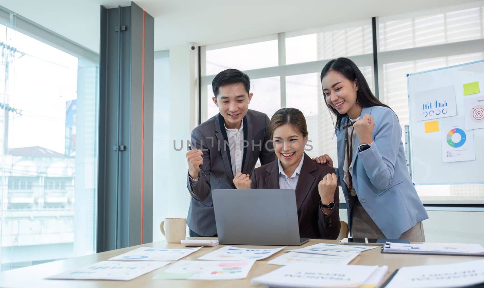 Group of Young Asian business team creative businesspeople coworker in office Happy to be successful partnership teamwork celebrating achievement and success concept..