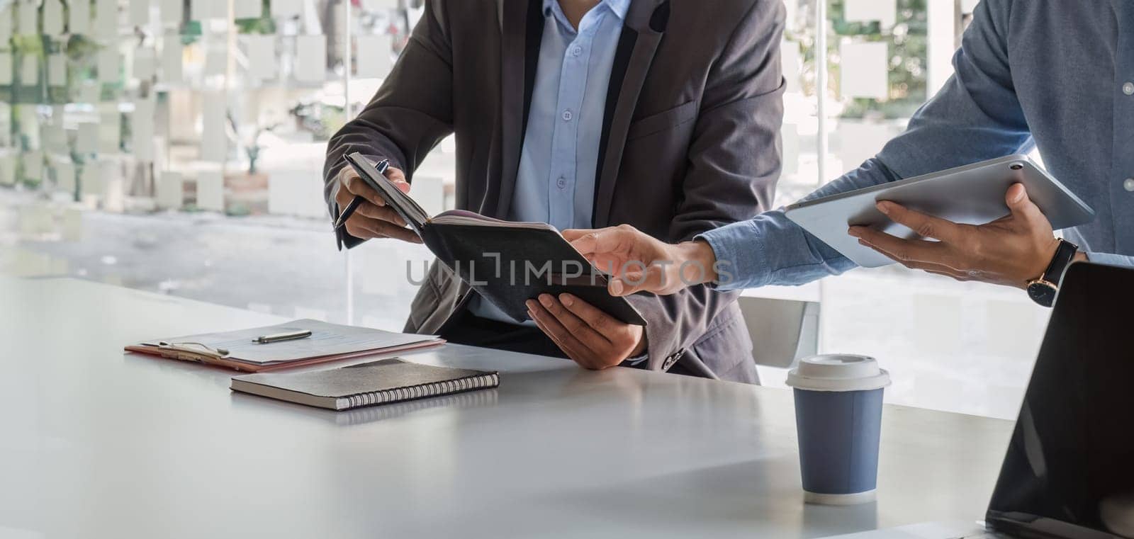 Business People Meeting using laptop computer,calculator,notebook,stock market chart paper for analysis Plans to improve quality next month. Conference Discussion Corporate Concept