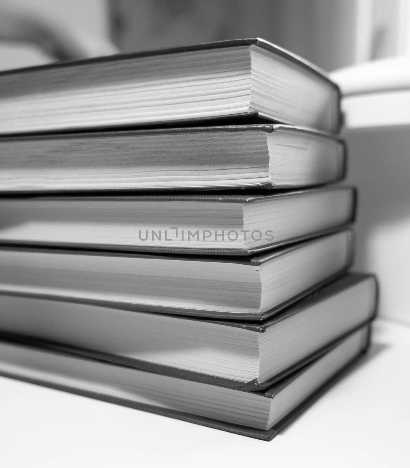 Stack of books on a white background. One book is yellow. by AnatoliiFoto