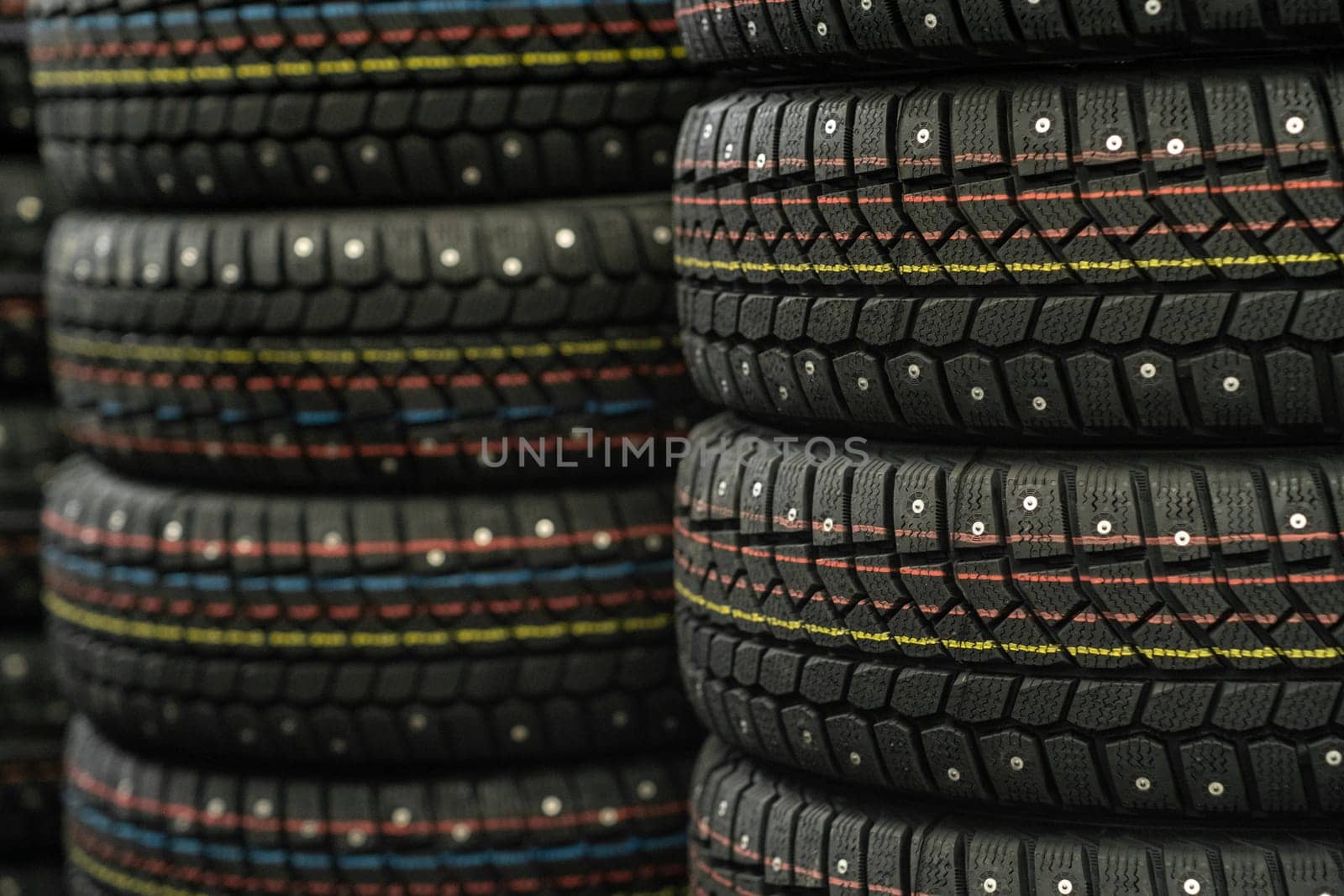 Sale of car tires for sale in the store. Many new winter tires lie by AnatoliiFoto
