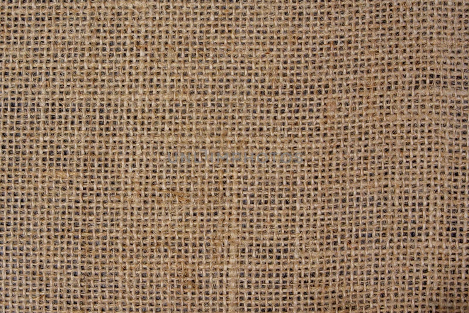 Close-up view of a burlap fabric showing its woven texture and rustic look, ideal as a natural background or material design element.