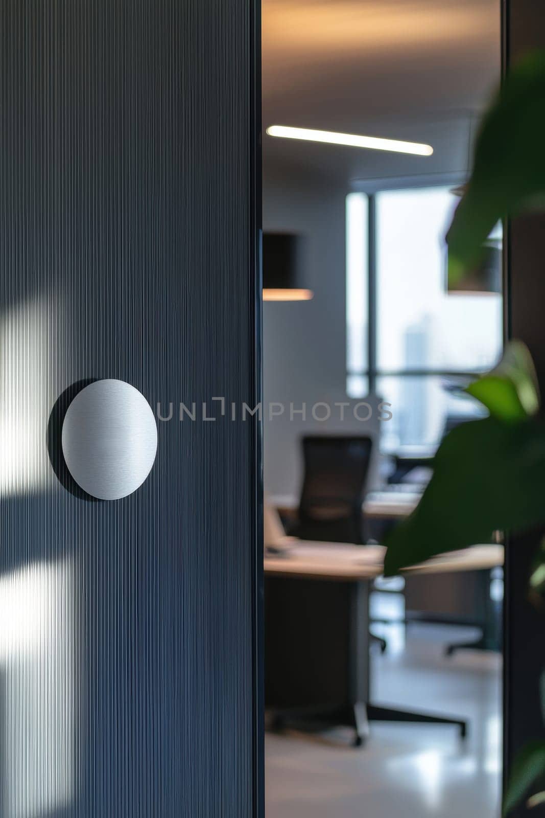A glossy, circular sticker with a professional company logo adheres to a polished steel surface in a sleek, modern office. features a clean industrial setting with natural light, stylish furnishings, and an open layout reflecting contemporary corporate aesthetics.