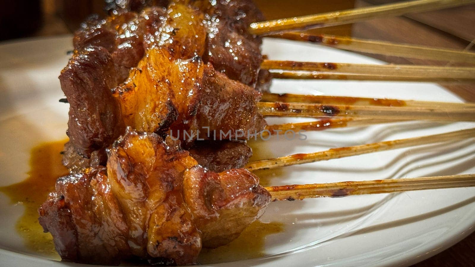 skewered beef meat on a grill, or barbecue bbq, locals called it beef satay showcasing their vibrant glaze and texture. Perfect representation of barbecue culture, grilling cuisine, and outdoor cooking enjoyment.
