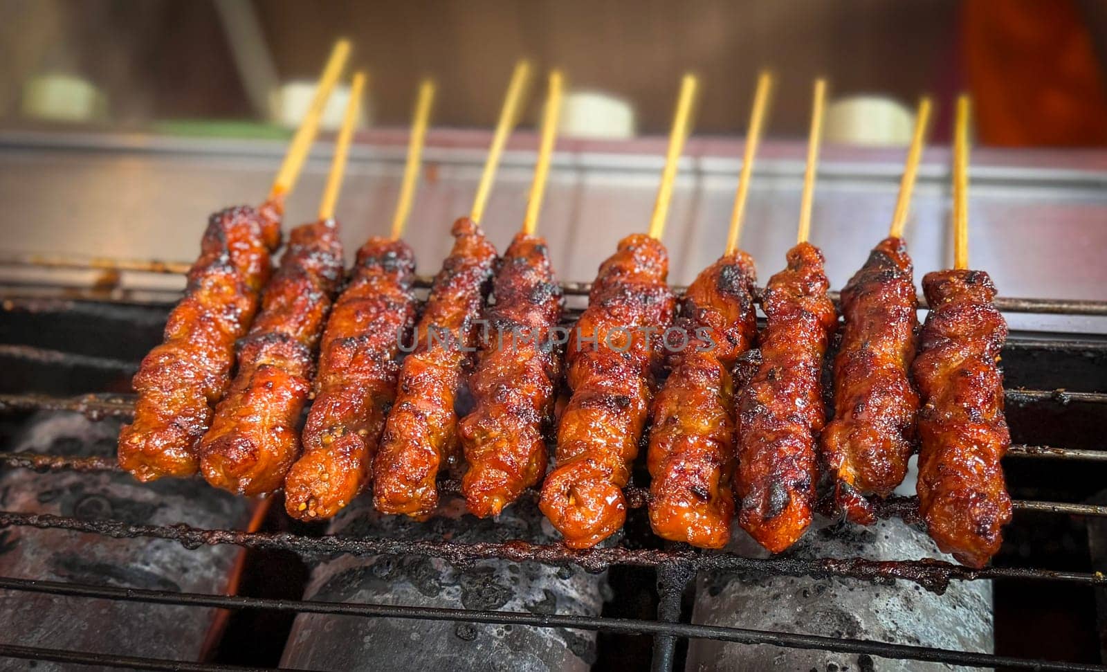 skewered beef meat on a grill, or barbecue bbq, locals called it beef satay showcasing their vibrant glaze and texture. Perfect representation of barbecue culture, grilling cuisine, and outdoor cooking enjoyment.