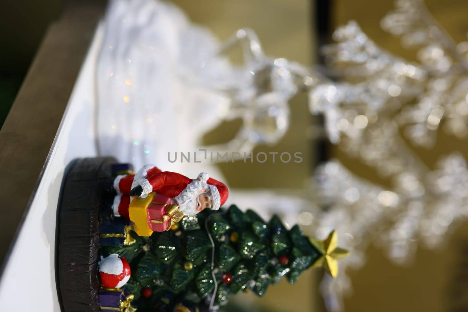 A charming Christmas decor showcasing Santa alongside a beautifully adorned and decorated tree filled with cheer