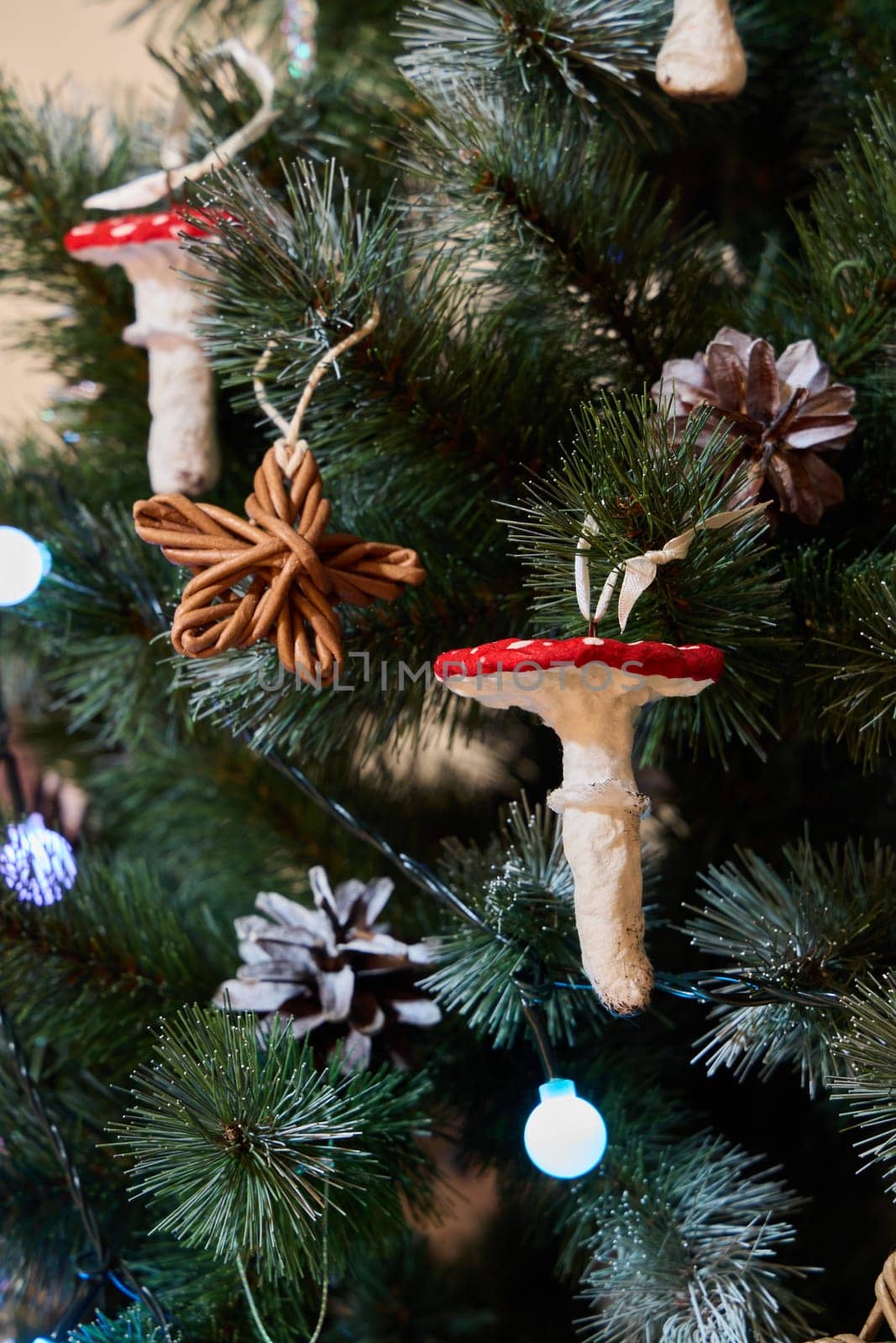 The festive decorations displayed on the Christmas tree include charming mushrooms, pine cones, and rustic stars