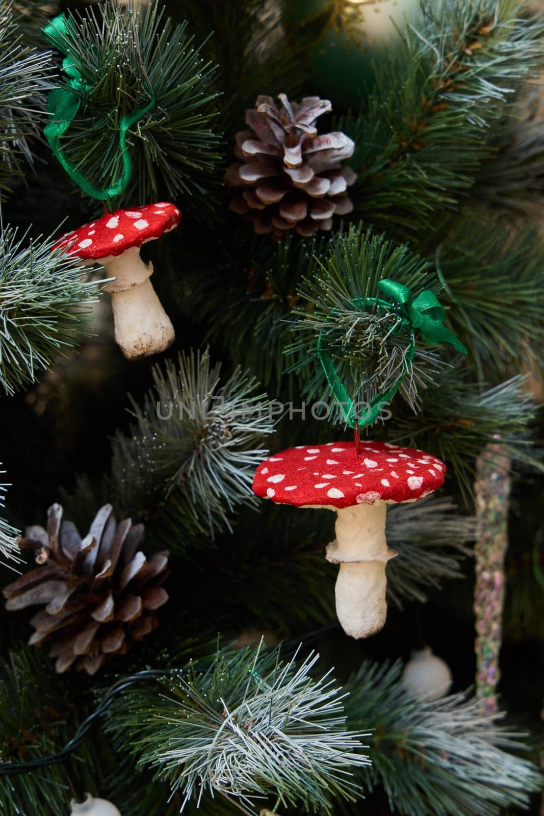 Charming and adorable mushroom ornaments beautifully adorn a decorated Christmas tree embellished with pinecones