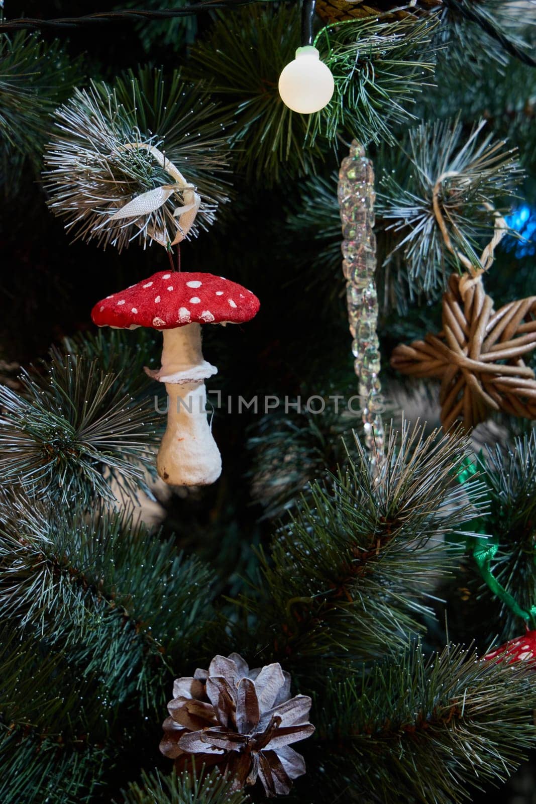 A beautifully adorned Christmas tree that showcases unique ornaments such as a mushroom and pinecone