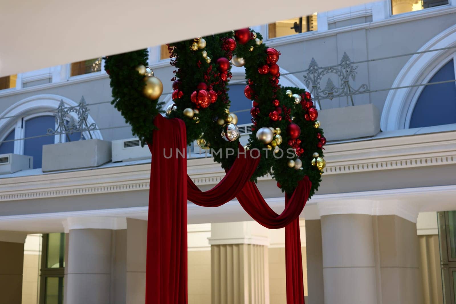 Gorgeously designed festive wreaths elegantly adorned with beautiful red drapes, ideal for capturing the holiday spirit