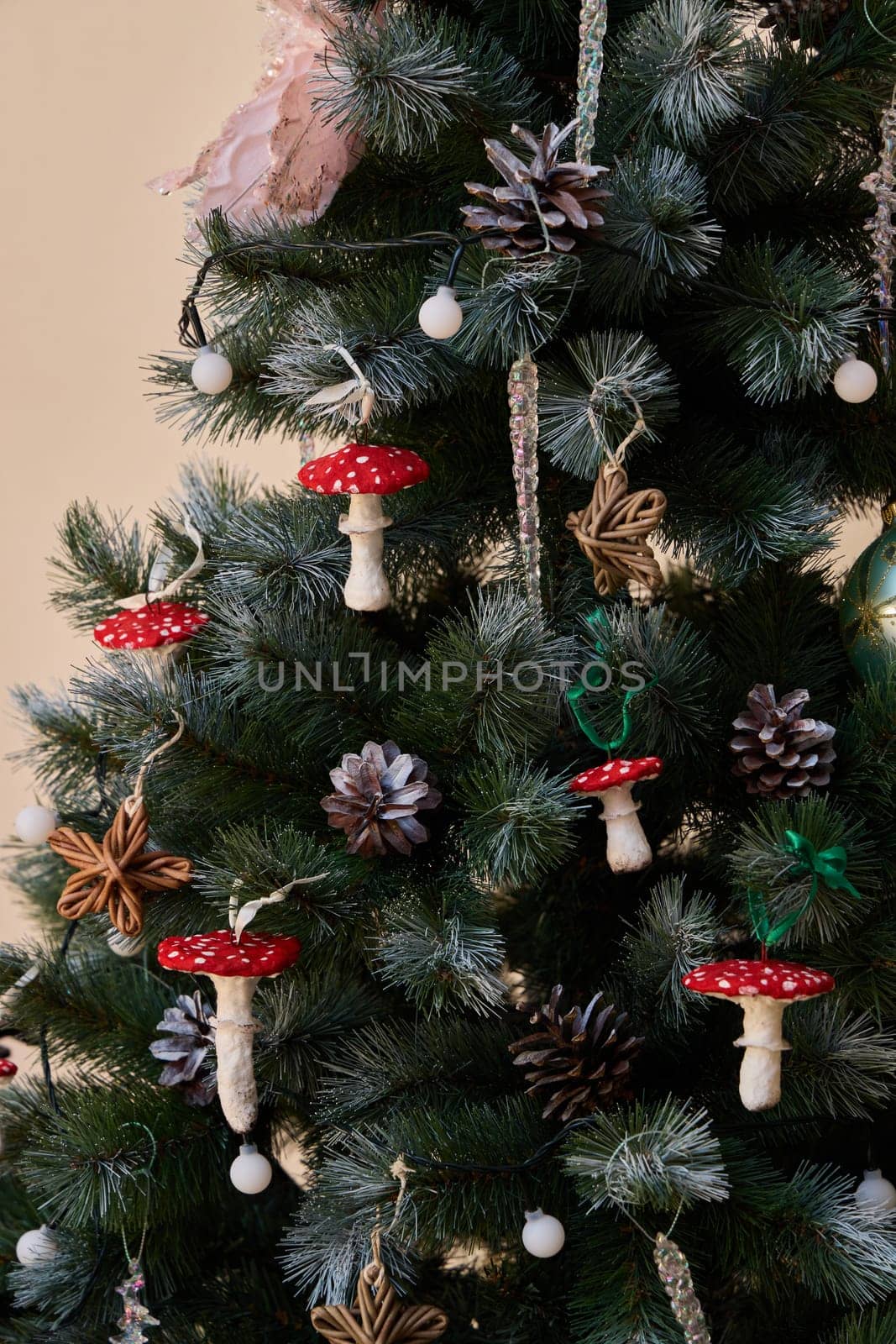 A festive Christmas tree adorned with colorful mushrooms, pinecones, and ornaments for a unique touch.