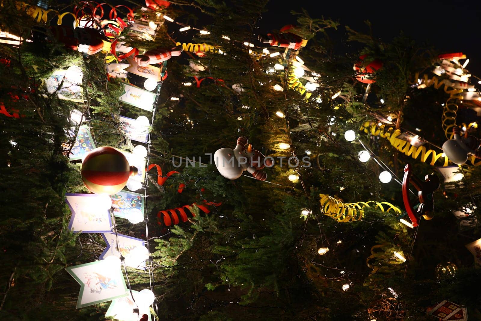 A beautifully decorated Christmas tree adorned with numerous vibrant ornaments and shimmering twinkling lights