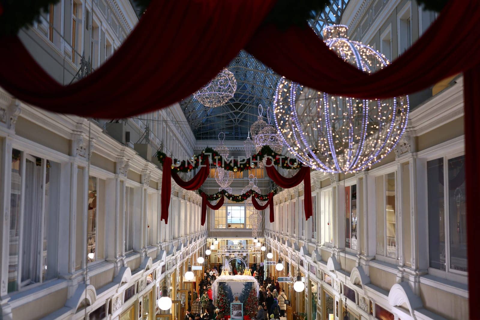 A beautifully decorated shopping mall adorned with colorful Christmas lights and ornaments, capturing holiday joy