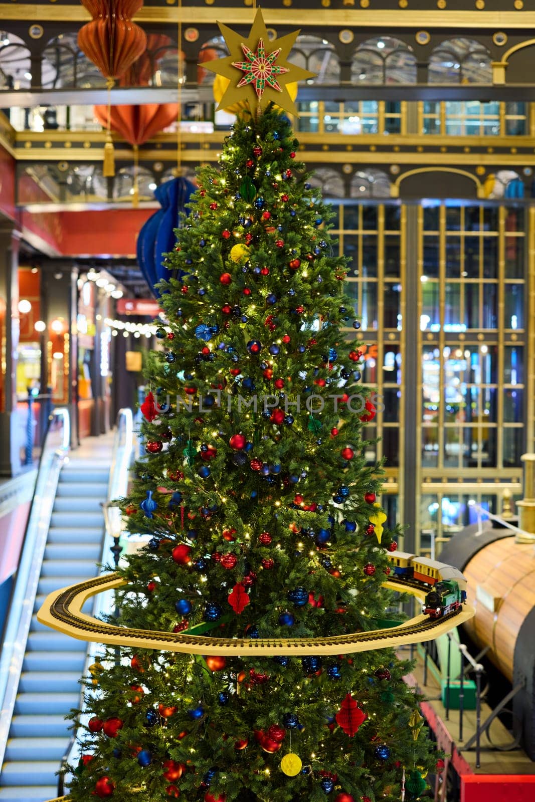 A joyfully decorated Christmas tree adorned with vibrant ornaments, creating a lively and festive atmosphere