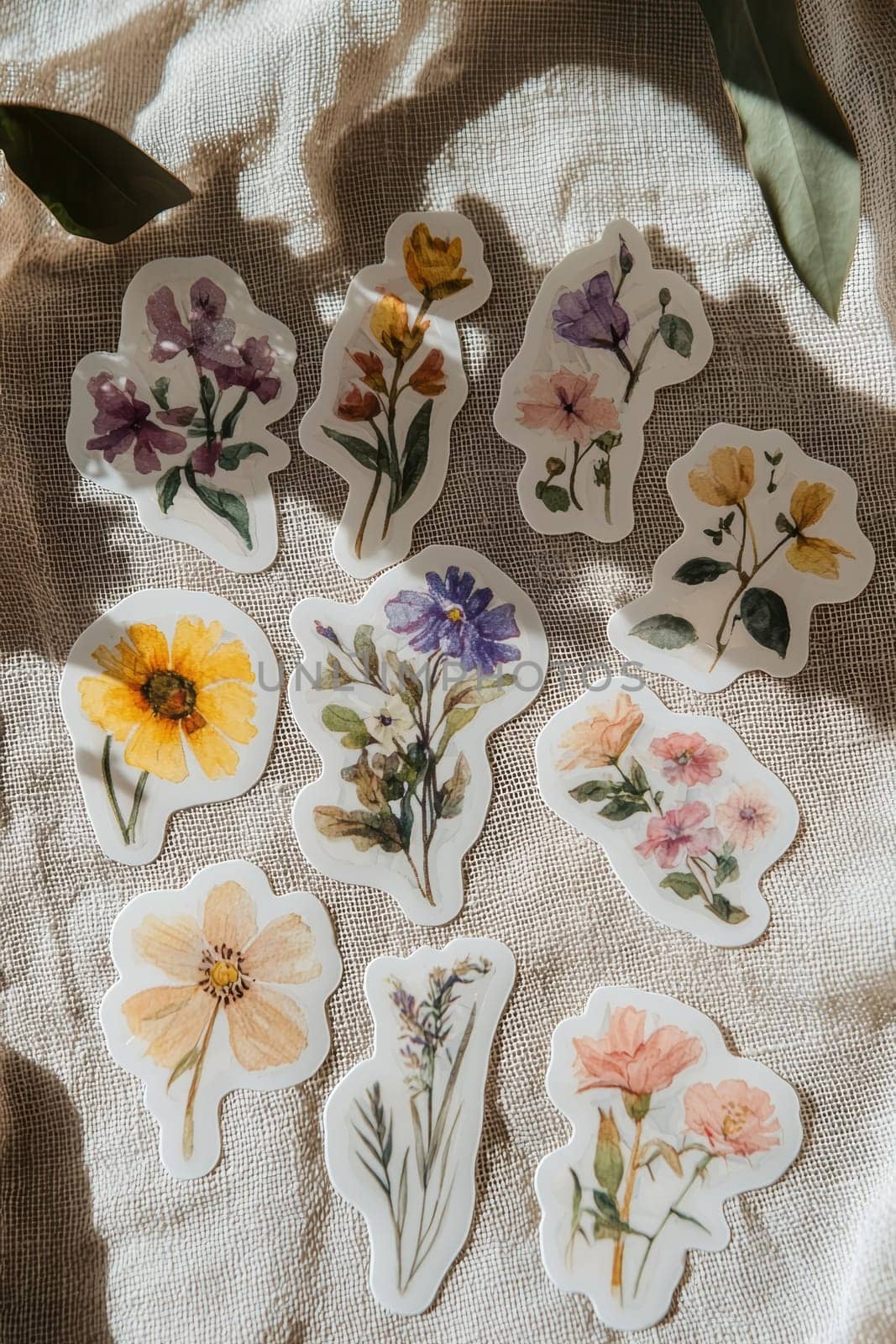 A collection of matte finish floral stickers featuring pastel colors, elegantly displayed on a textured linen fabric. ideal for use in crafts, journaling, or decoration, the design exudes a sense of calm and subtle elegance.